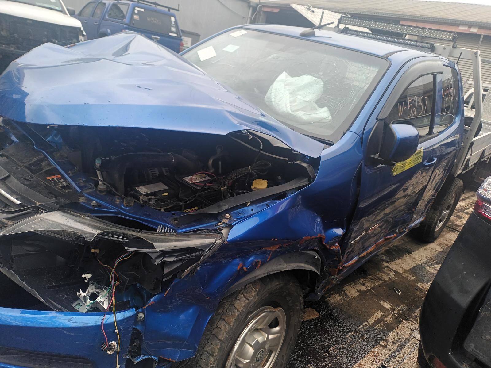 A Blue Truck with the Hood Up is Sitting in a Parking Lot — South West 4WD Wreckers In Brisbane, QLD