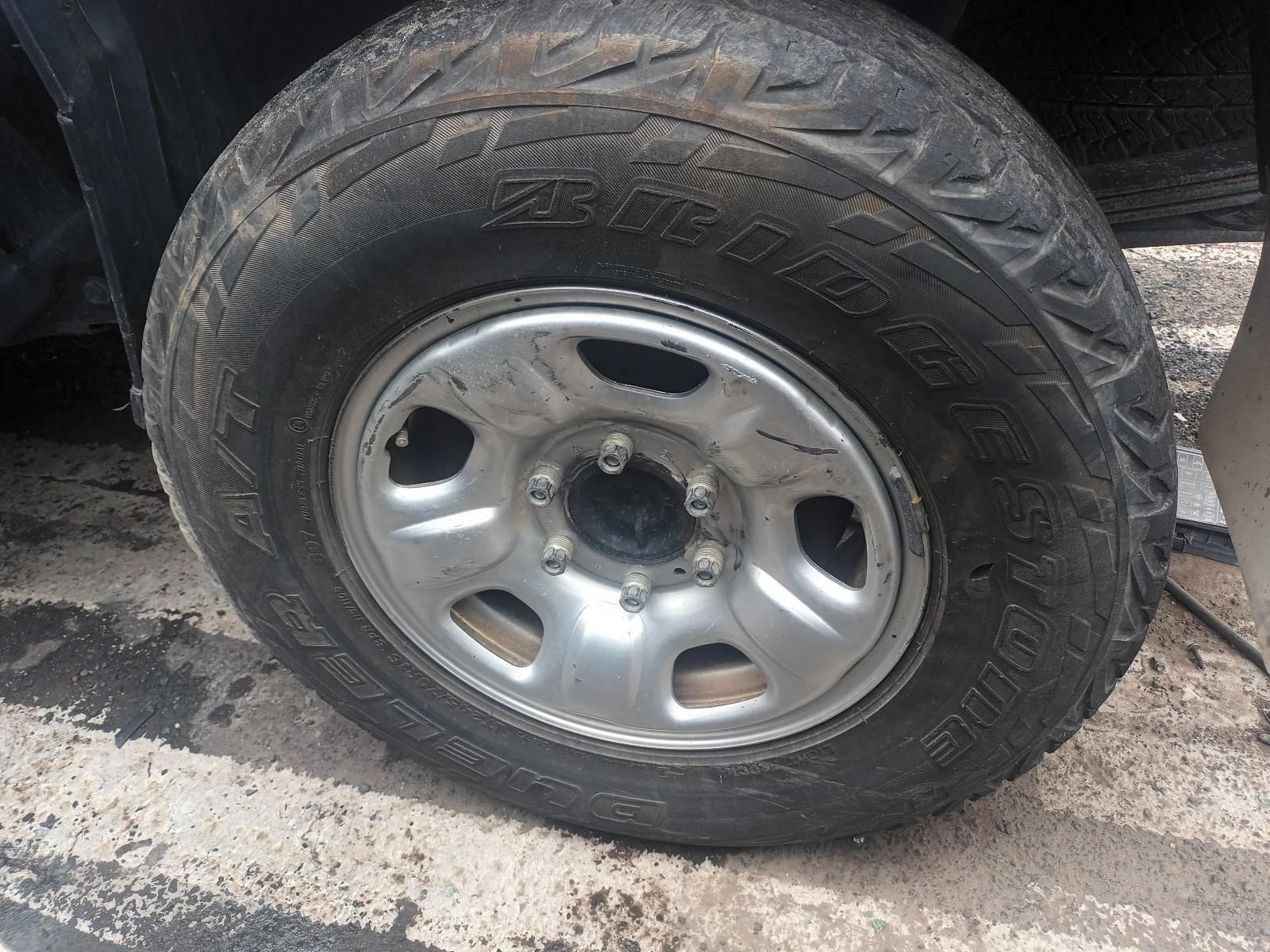 A Close Up of a Tire on a Car in a Parking Lot — South West 4WD Wreckers In Brisbane, QLD 