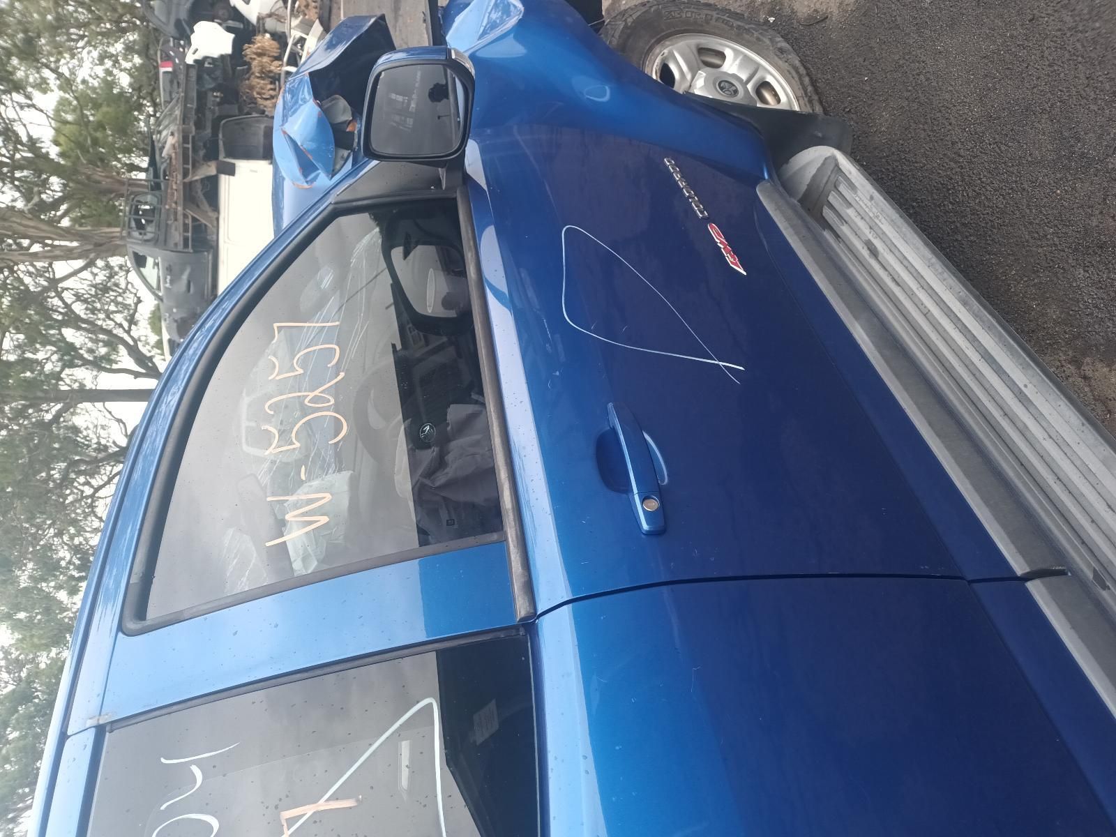 A Blue Truck is Parked on the Side of the Road — South West 4WD Wreckers In Brisbane, QLD