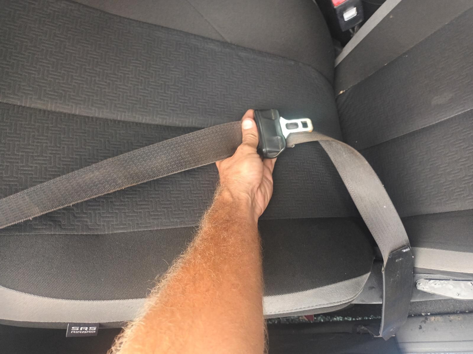 A Person is Holding a Seat Belt in a Car — South West 4WD Wreckers In Brisbane, QLD