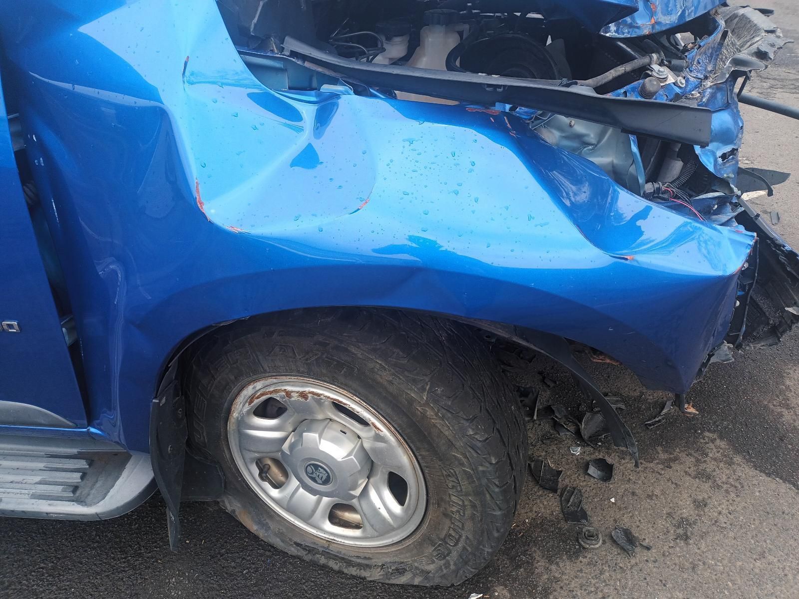 A Blue Car Has Been Damaged in an Accident and Has a Flat Tire — South West 4WD Wreckers In Brisbane, QLD