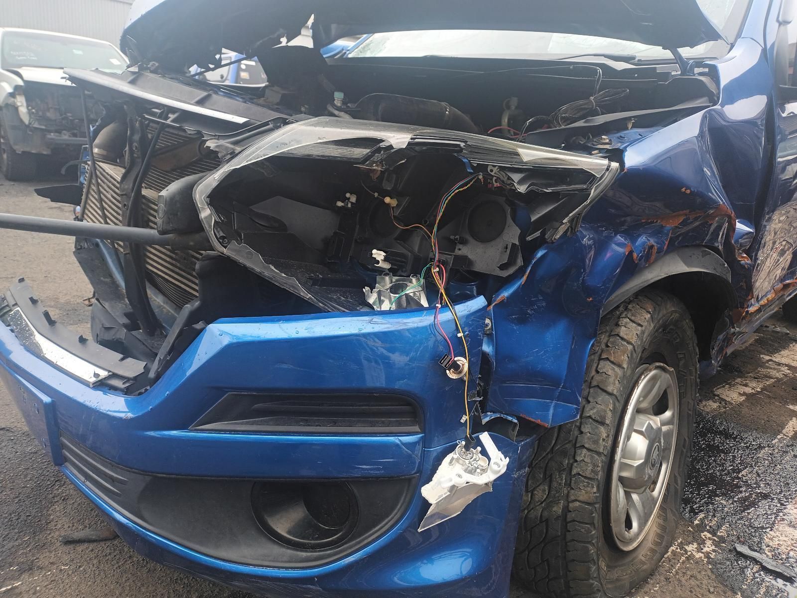 A Blue Car with the Hood Open is Sitting on the Side of the Road — South West 4WD Wreckers In Brisbane, QLD