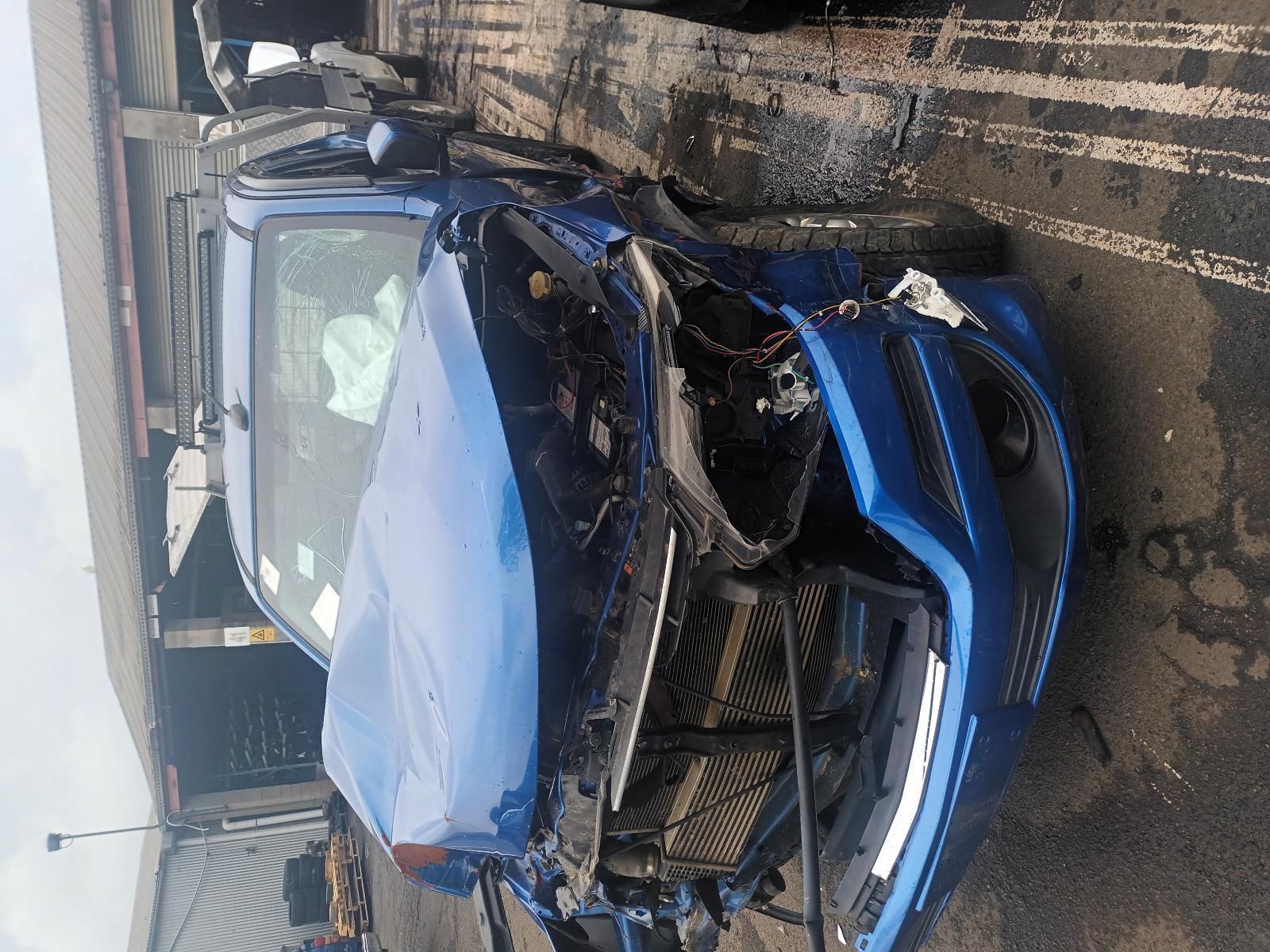 A Blue Car is Sitting on the Side of the Road — South West 4WD Wreckers In Brisbane, QLD