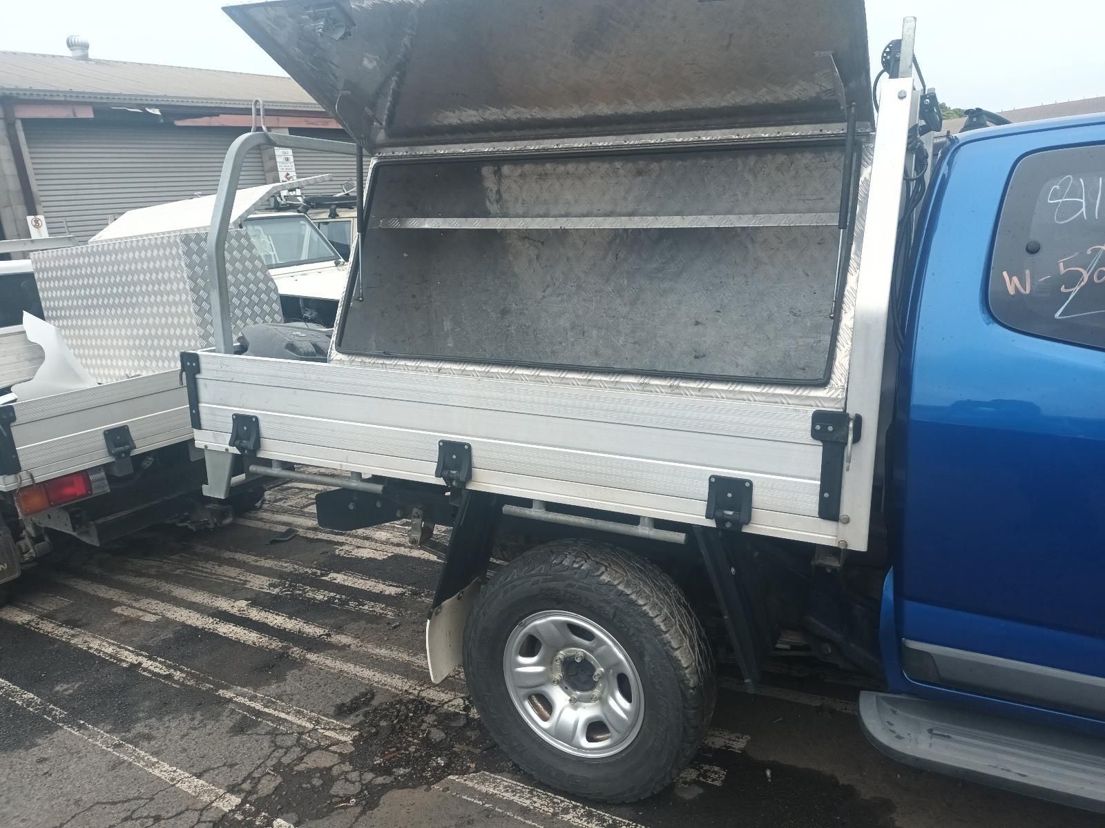 A Blue Truck with a Toolbox on the Back is Parked in a Parking Lot — South West 4WD Wreckers In Brisbane, QLD