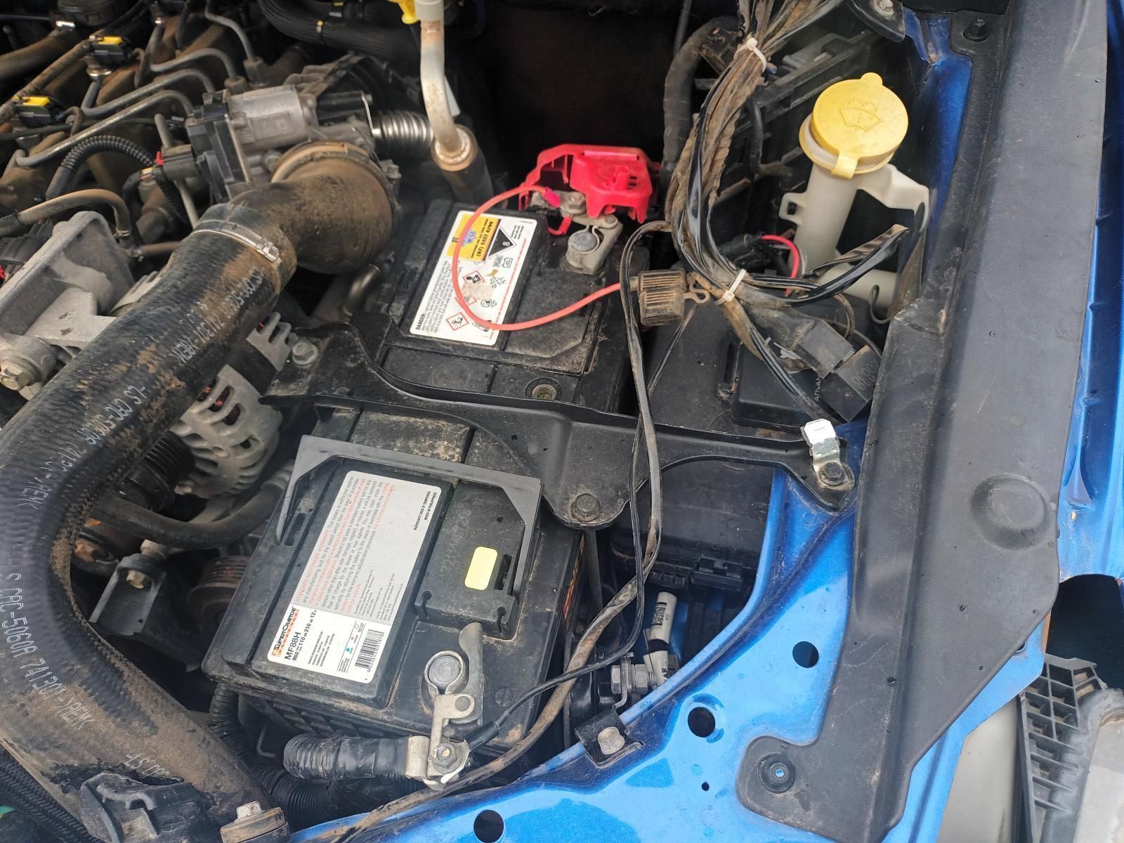 A Blue Car with a Battery in the Engine Compartment — South West 4WD Wreckers In Brisbane, QLD