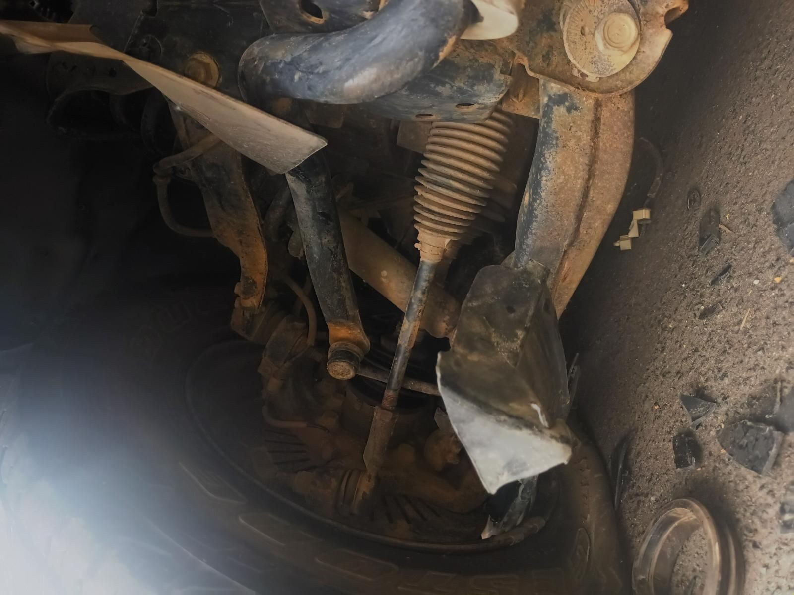 A cLose Up of the Underside of a Car with a Piece of Paper Laying on the Ground — South West 4WD Wreckers In Brisbane, QLD