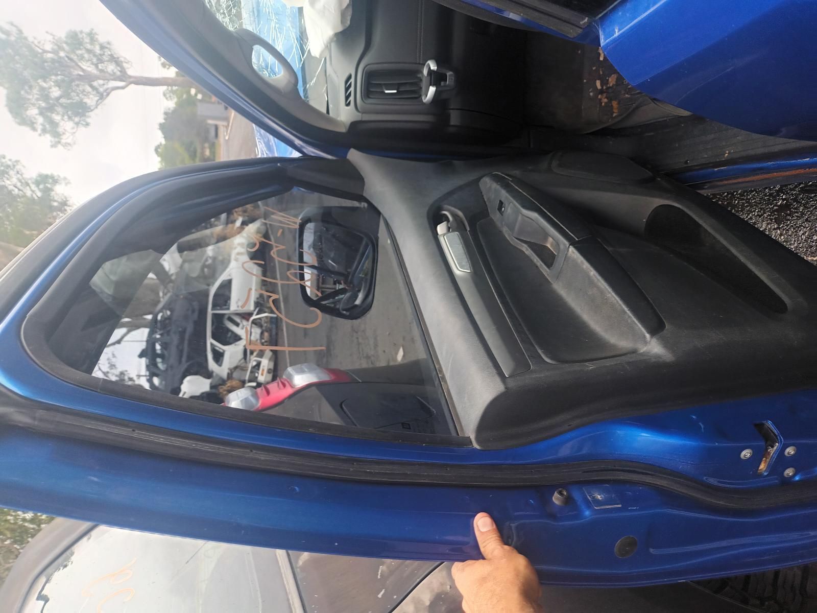 A Person is Pointing at the Door of a Blue Car — South West 4WD Wreckers In Brisbane, QLD