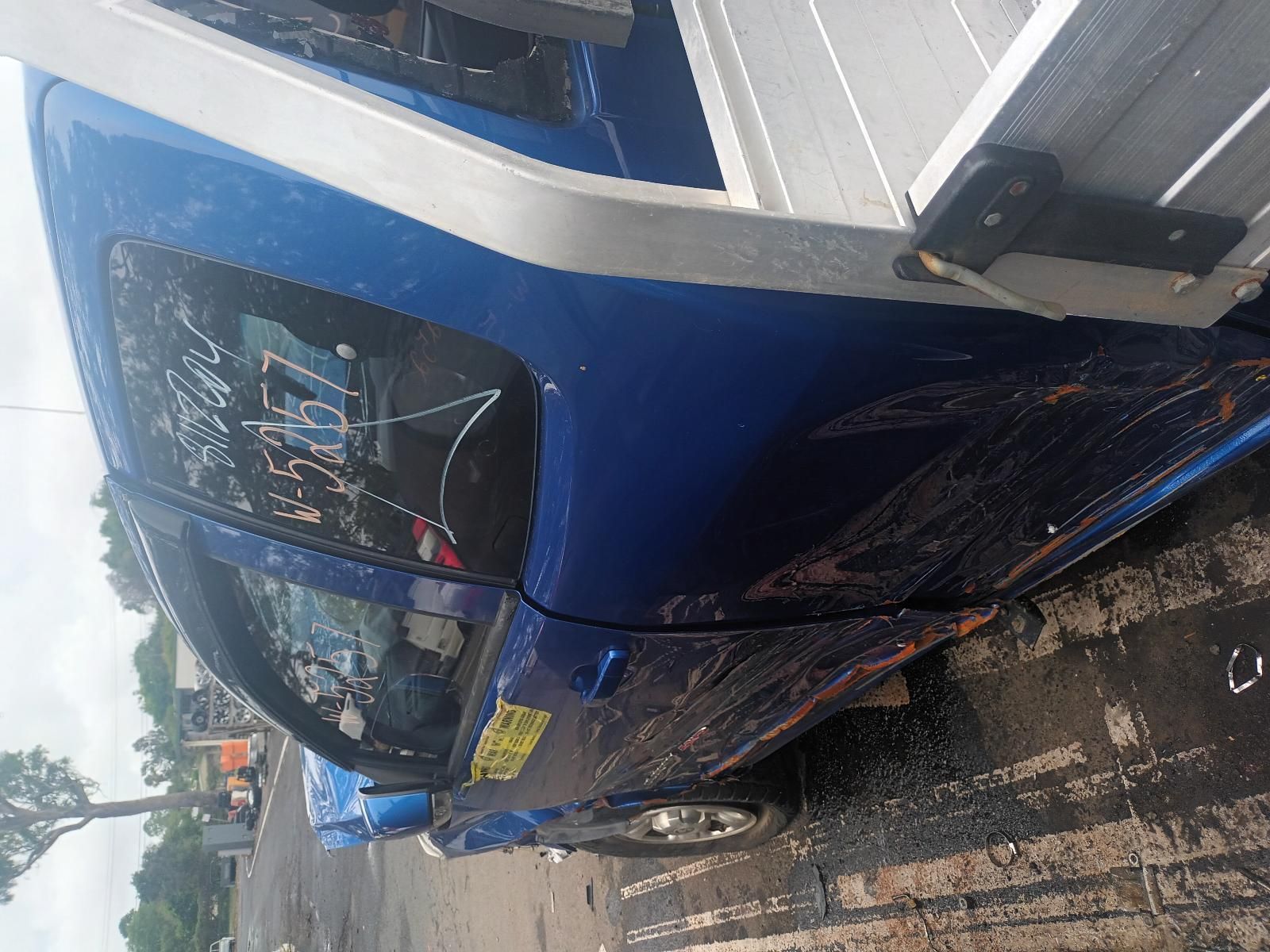 A Blue Car is Parked on the Side of the Road — South West 4WD Wreckers In Brisbane, QLD