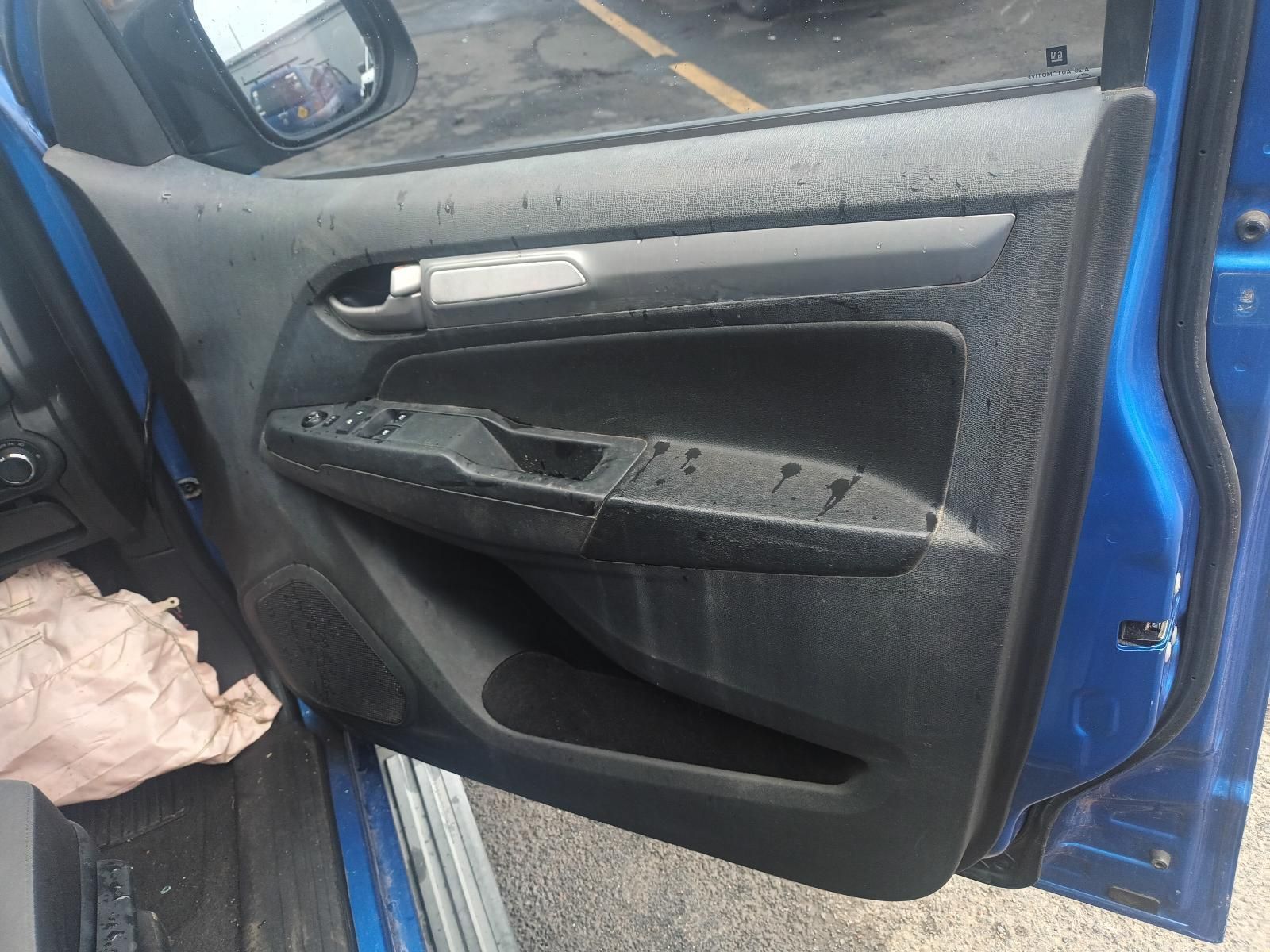 A Blue Car is Parked in a Parking Lot with the Door Open — South West 4WD Wreckers In Brisbane, QLD