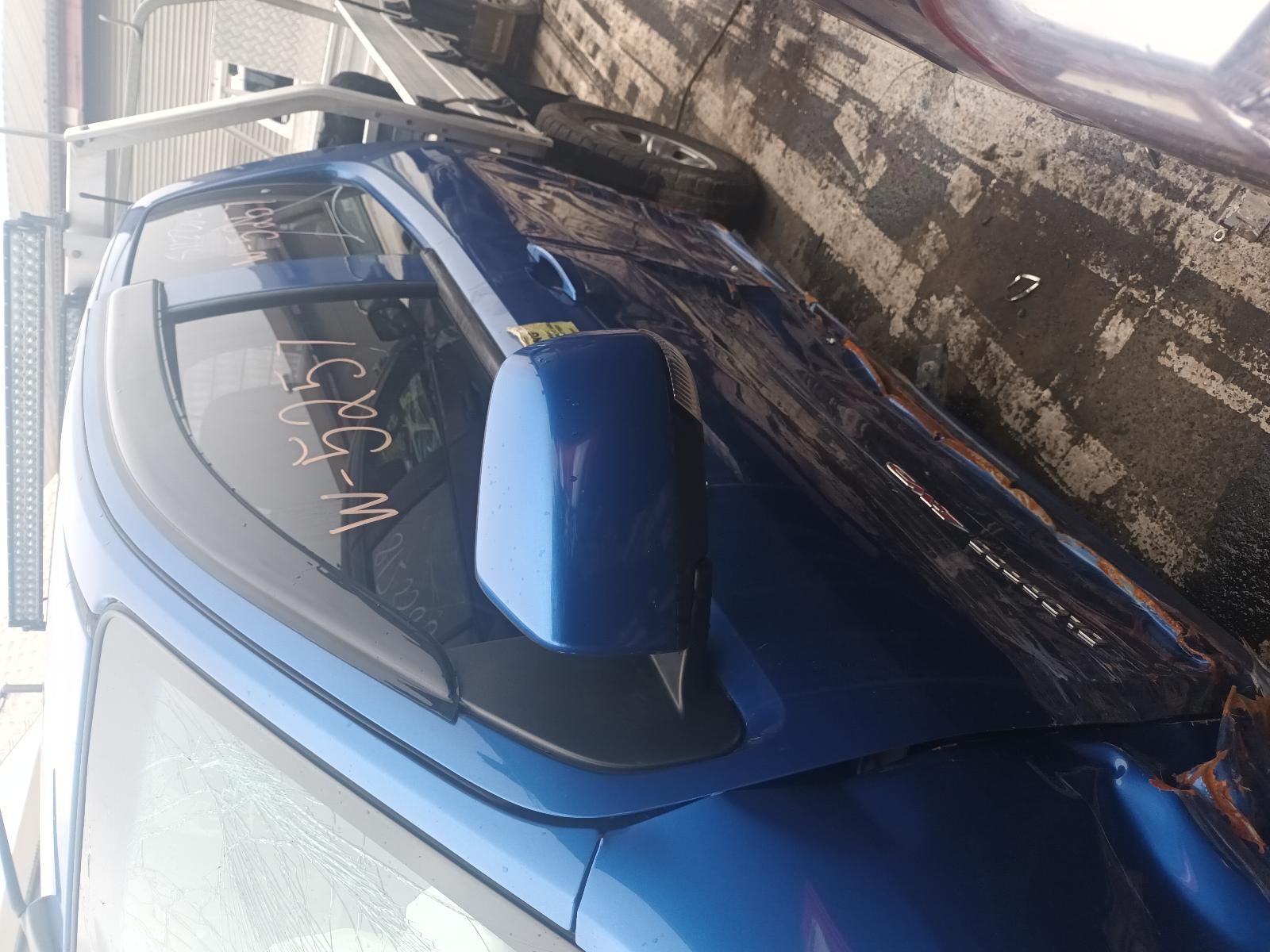 A Blue Car is Parked on the Side of the Road — South West 4WD Wreckers In Brisbane, QLD