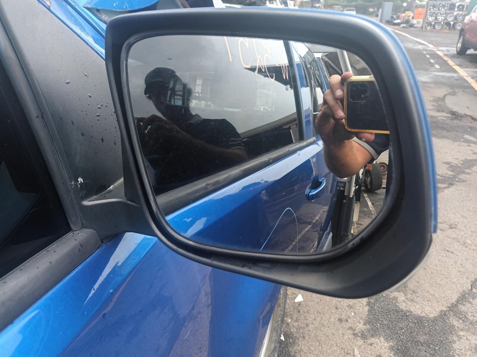 A Person is Taking a Picture of Their Reflection in the Side Mirror — South West 4WD Wreckers In Brisbane, QLD