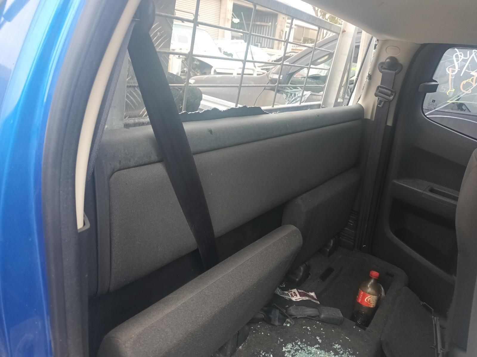 The Back of a Blue Truck with a Bottle of Coca Cola in the Back Seat — South West 4WD Wreckers In Brisbane, QLD