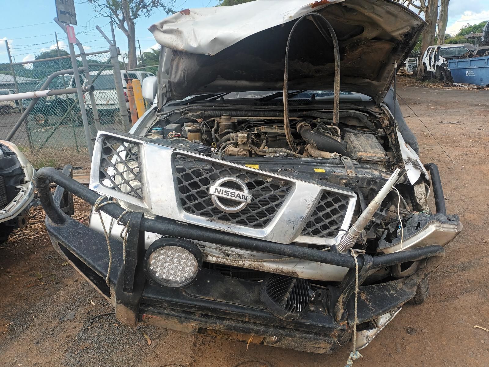 A Nissan Truck with the Hood Up is Sitting on the Ground — South West 4WD Wreckers In Brisbane, QLD