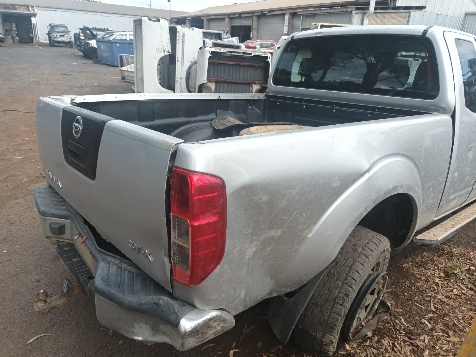 A Silver Nissan Pickup Truck is Parked in a Parking Lot — South West 4WD Wreckers In Brisbane, QLD