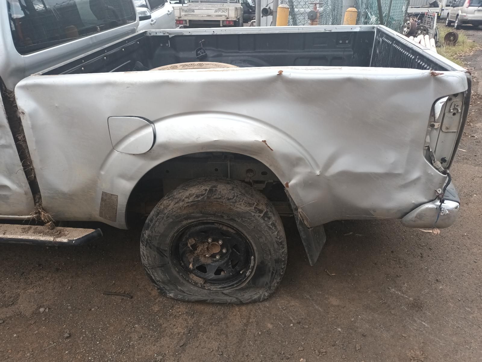A Truck with a Flat Tire is Parked on the Side of the Road — South West 4WD Wreckers In Brisbane, QLD