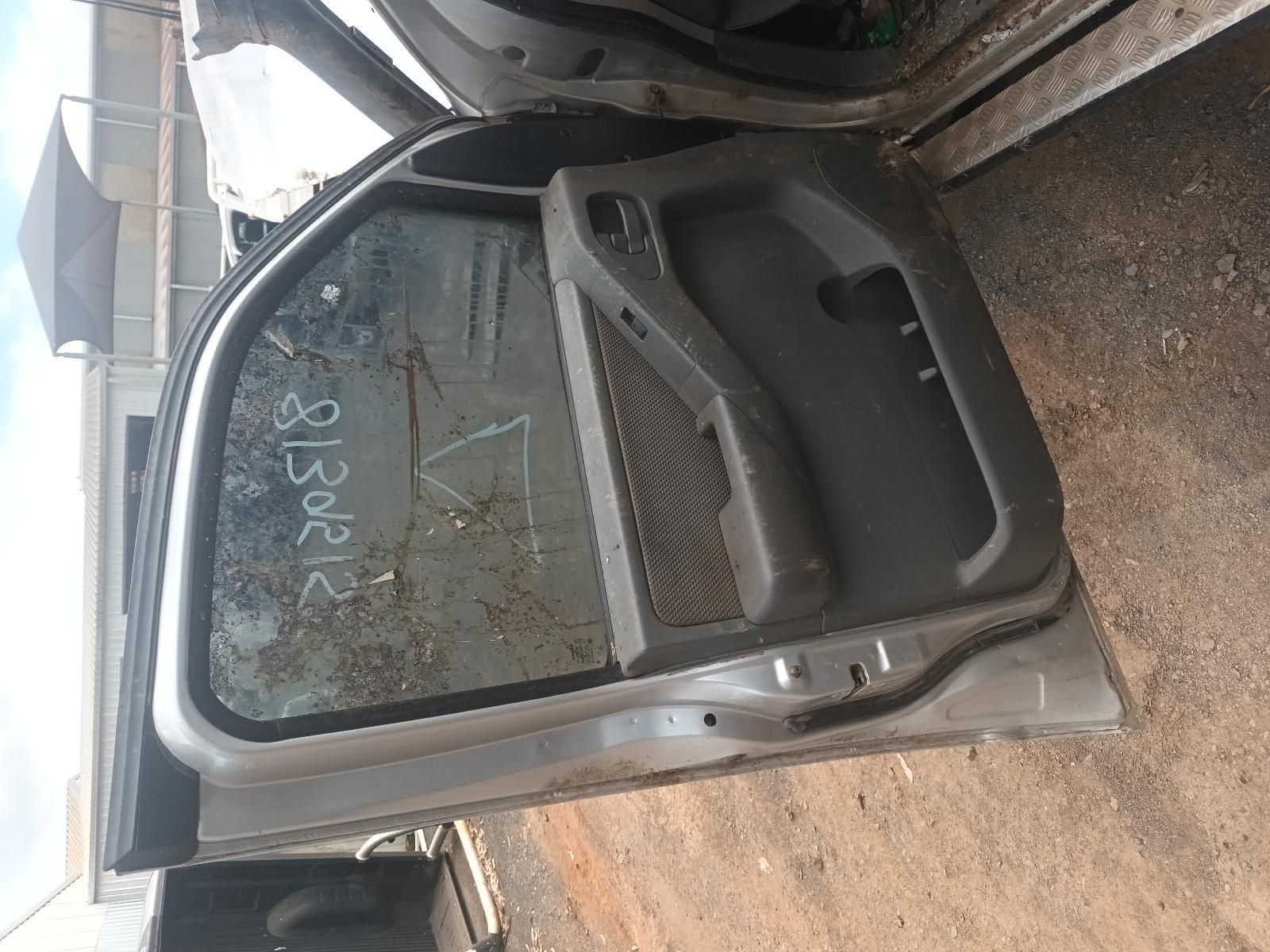 A Car Door is Sitting on the Ground Next to a Truck — South West 4WD Wreckers In Brisbane, QLD