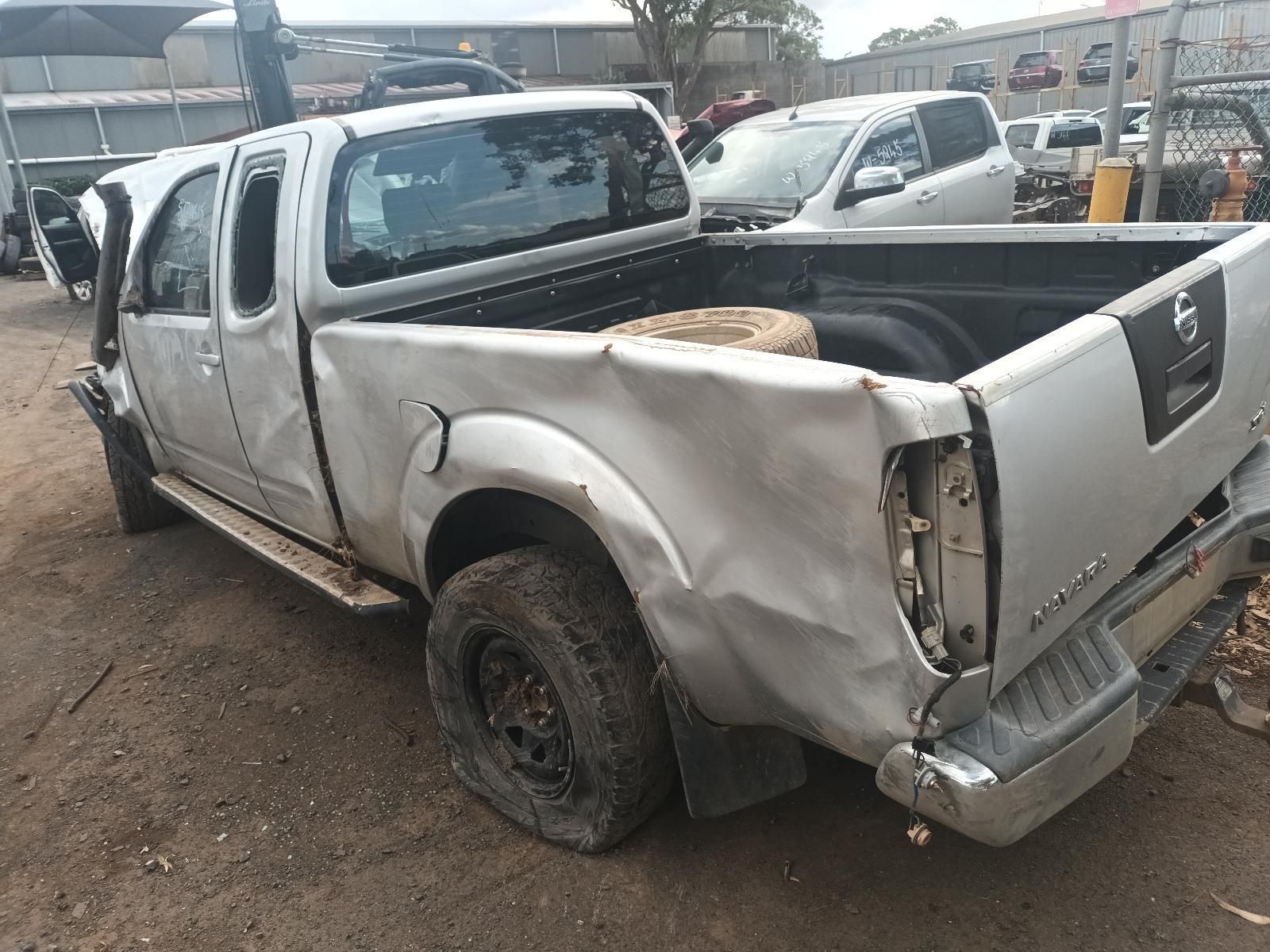 A Silver Pickup Truck With a Damaged Bed is Parked in a Lot — South West 4WD Wreckers In Brisbane, QLD