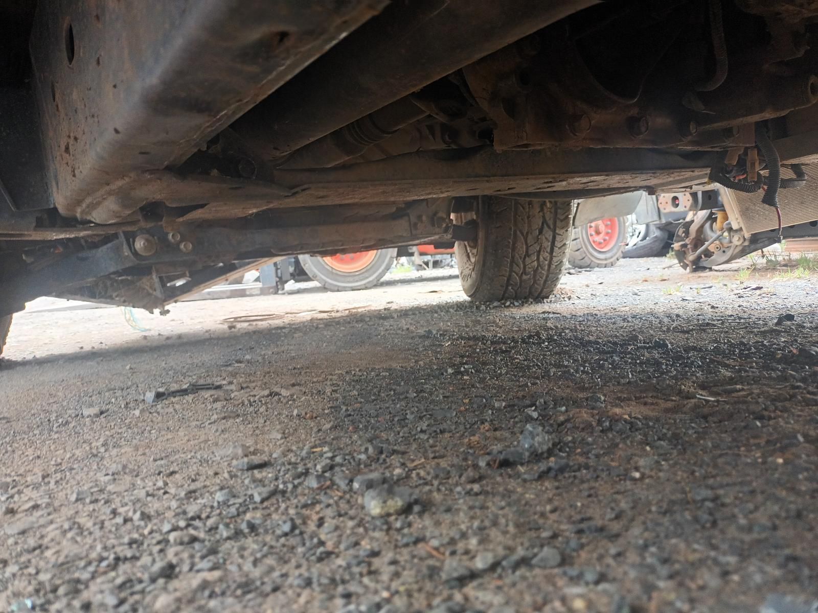 A Close Up of the Underside of a Car on a Gravel Road — South West 4WD Wreckers In Brisbane, QLD