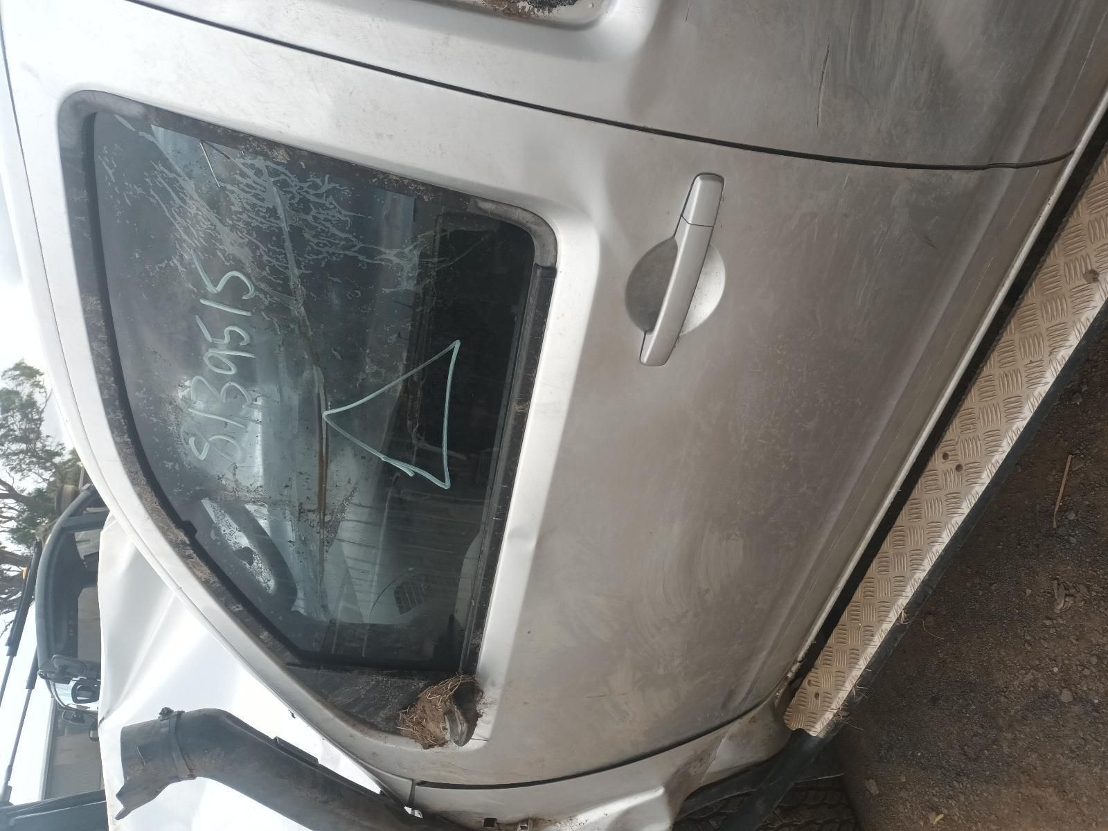 A Silver Car with a Broken Door is Sitting on the Ground — South West 4WD Wreckers In Brisbane, QLD