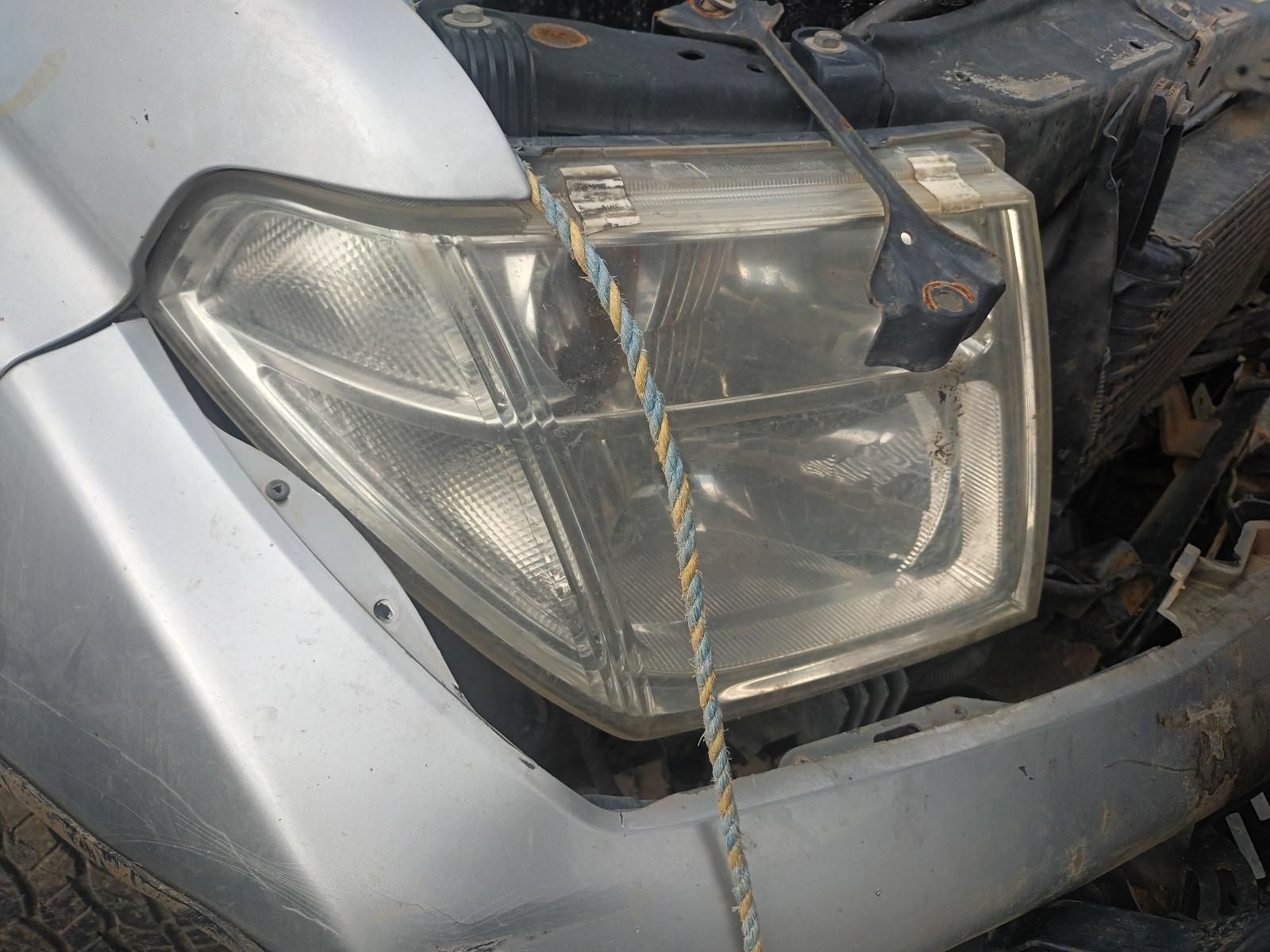 A Close Up of a Car Headlight with a Rope Attached to It — South West 4WD Wreckers In Brisbane, QLD