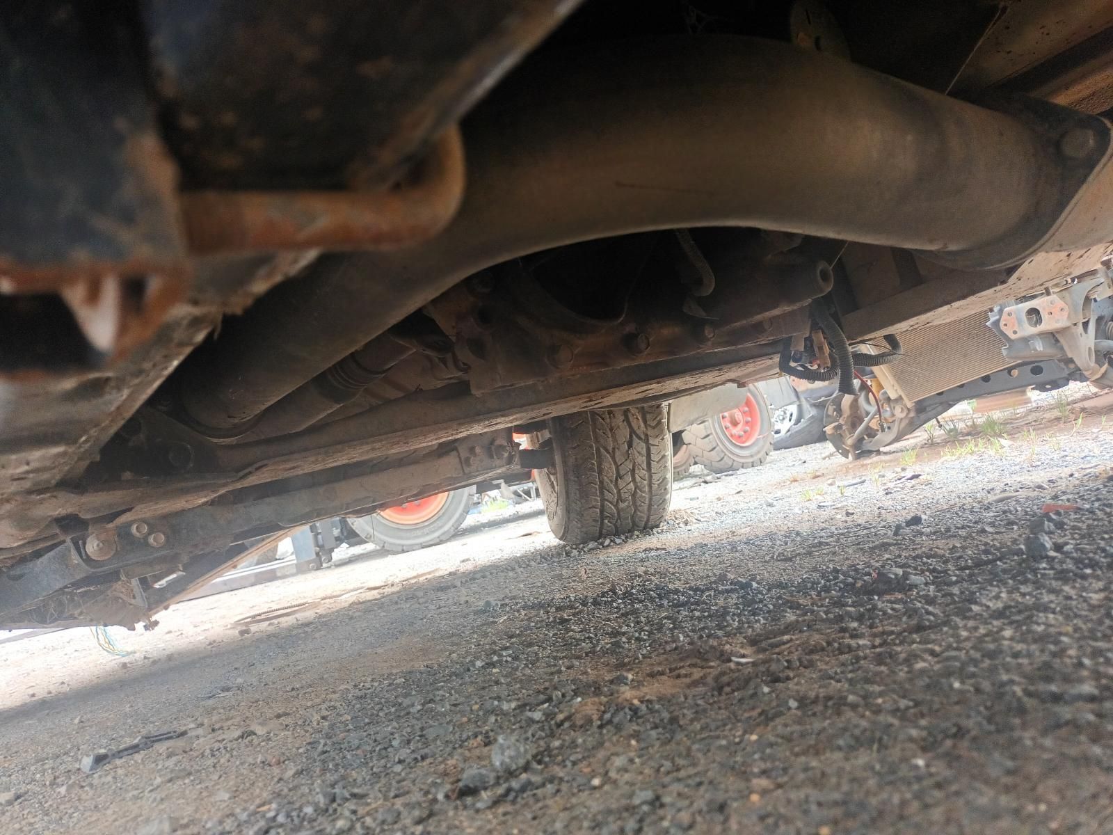A Close Up of the Underside of a Car on a Gravel Road — South West 4WD Wreckers In Brisbane, QLD