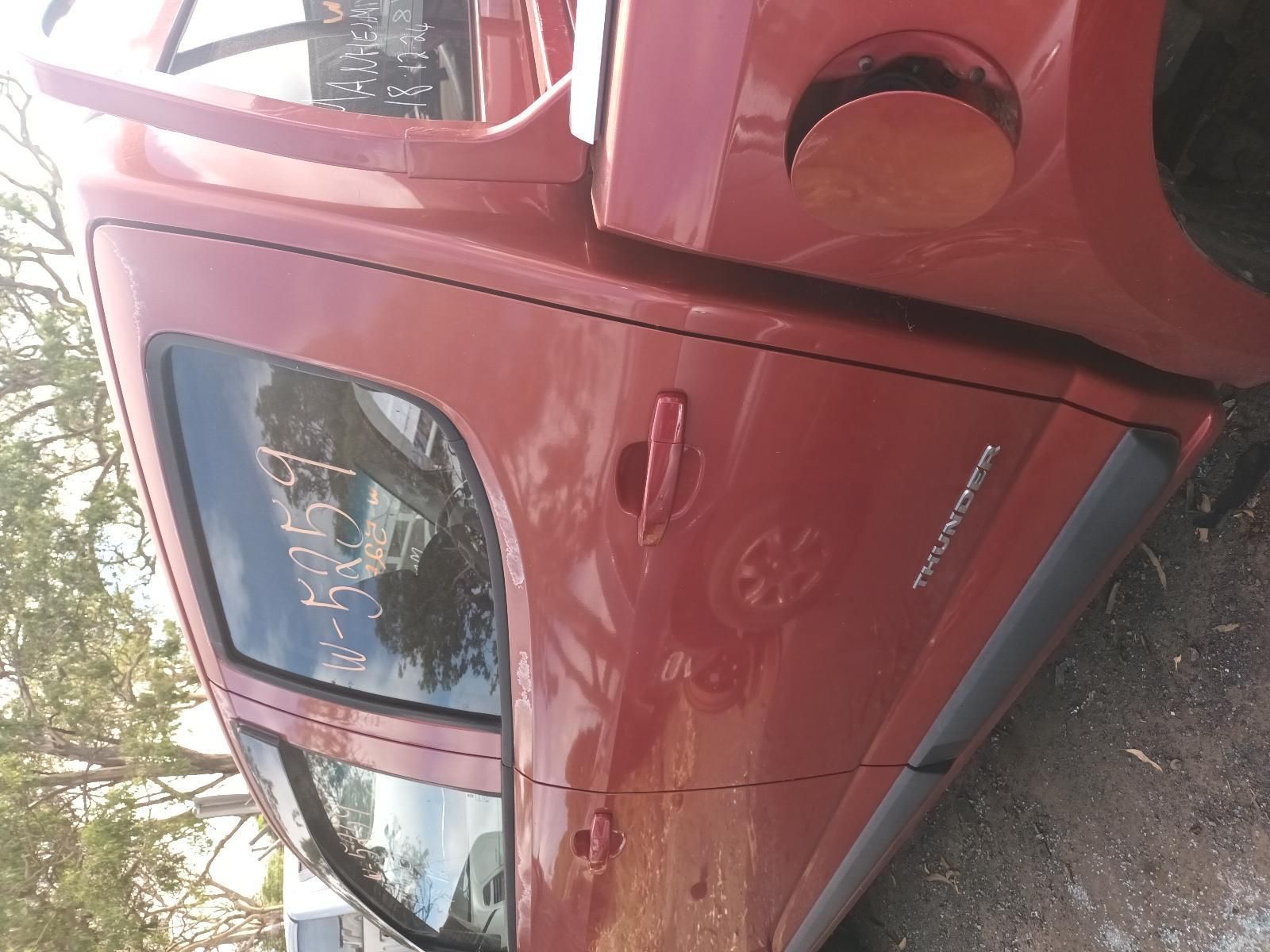 A Red Truck is Parked on the Side of the Road — South West 4WD Wreckers In Brisbane, QLD