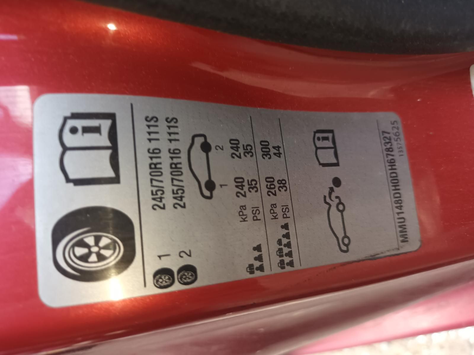 A Close Up of a Tire Sticker on a Red Car — South West 4WD Wreckers In Brisbane, QLD