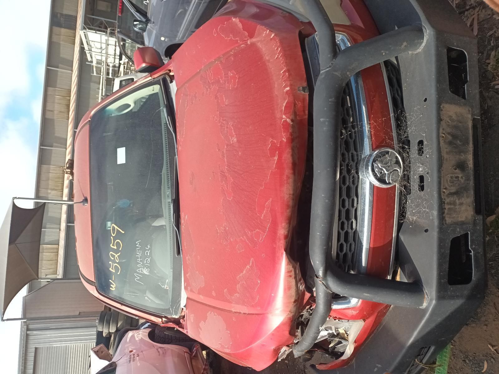A Red Truck with a Black Bumper is Parked in a Lot — South West 4WD Wreckers In Brisbane, QLD