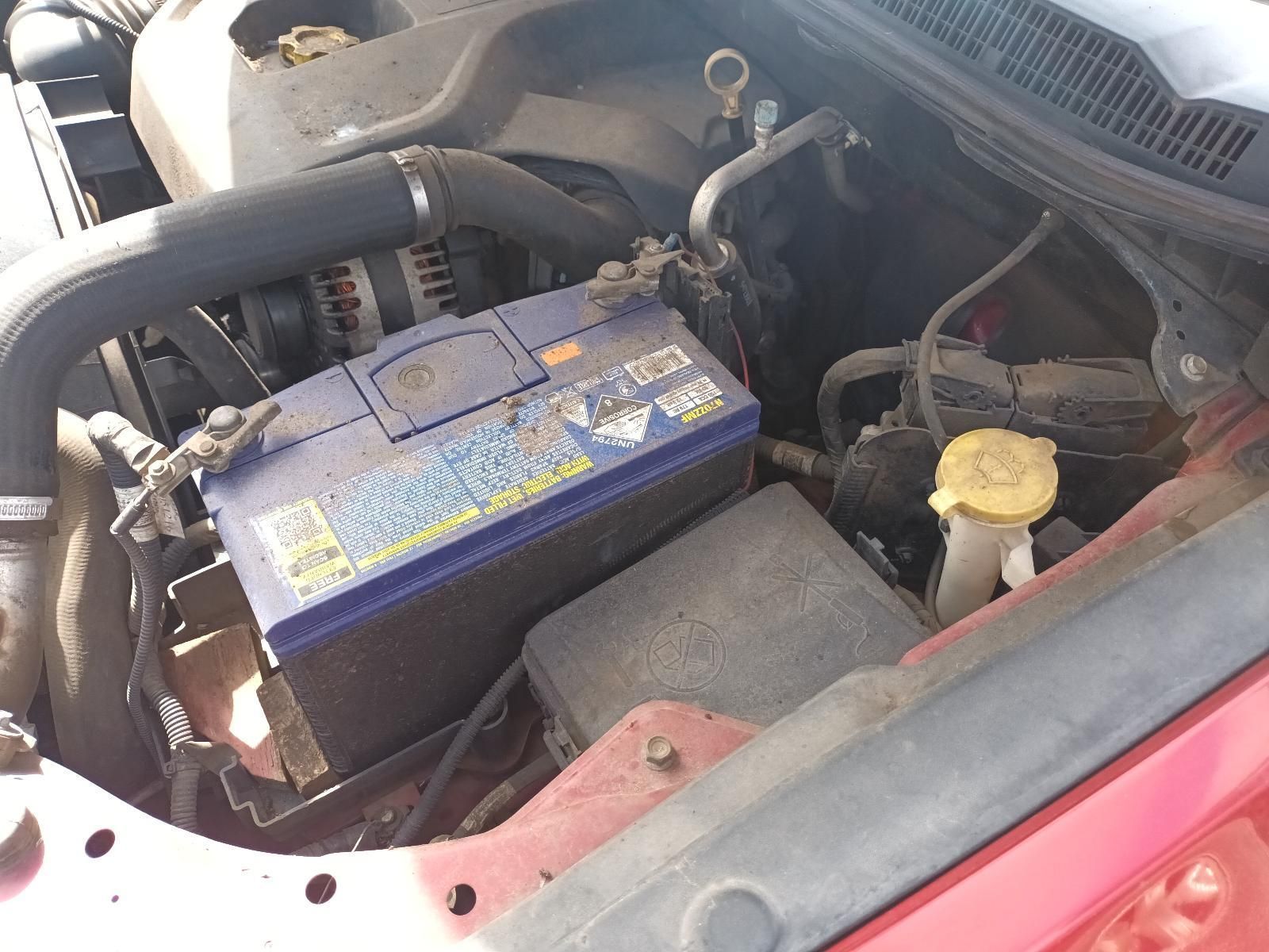 A Blue Battery is Sitting Under the Hood of a Car — South West 4WD Wreckers In Brisbane, QLD