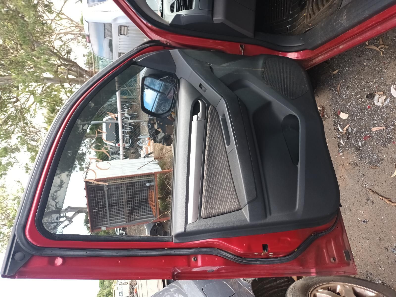 A Red Car with the Door Open is Parked on the Side of the Road — South West 4WD Wreckers In Brisbane, QLD