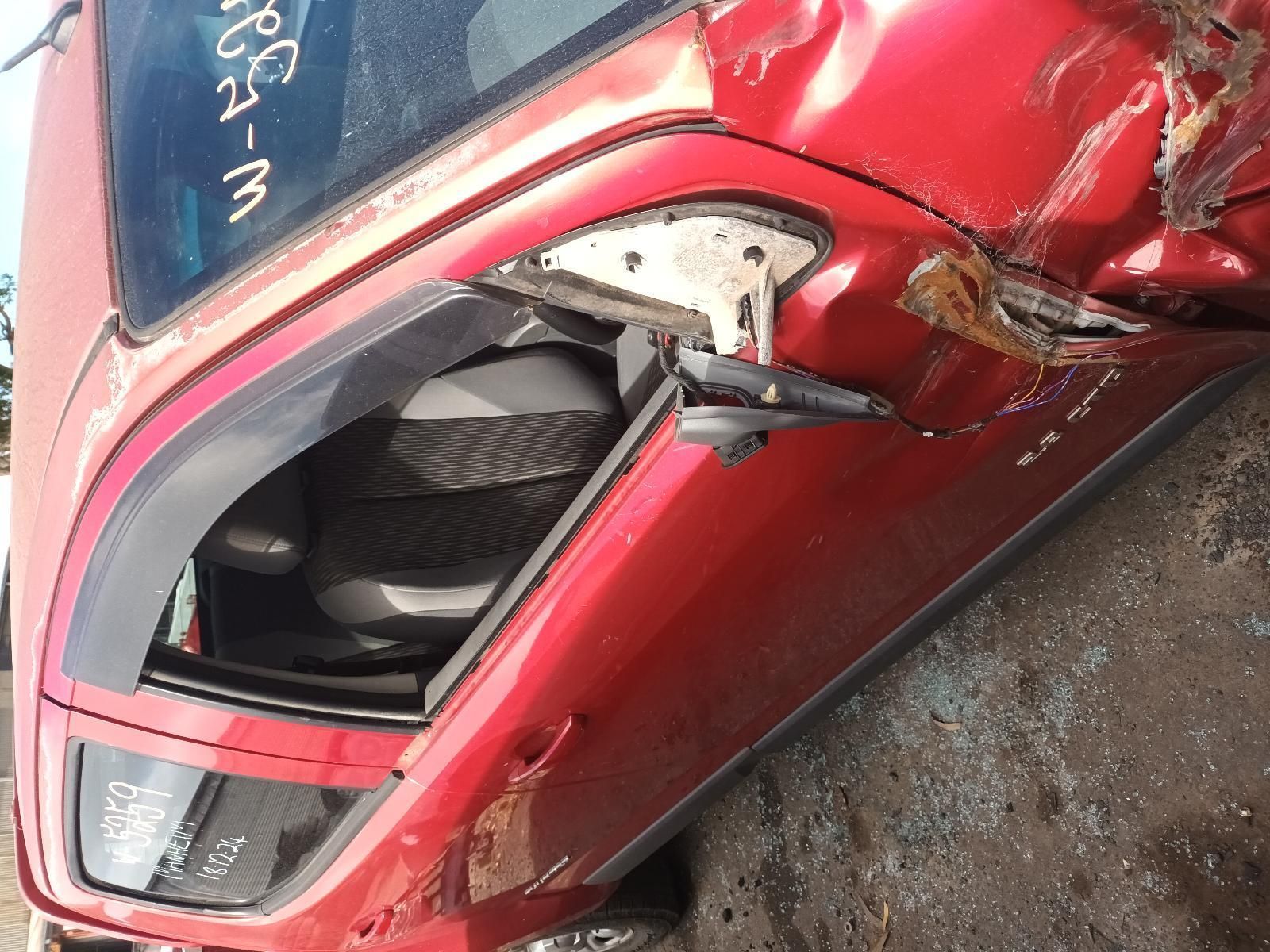 A Red Car is Laying on the Ground with the Door Open — South West 4WD Wreckers In Brisbane, QLD