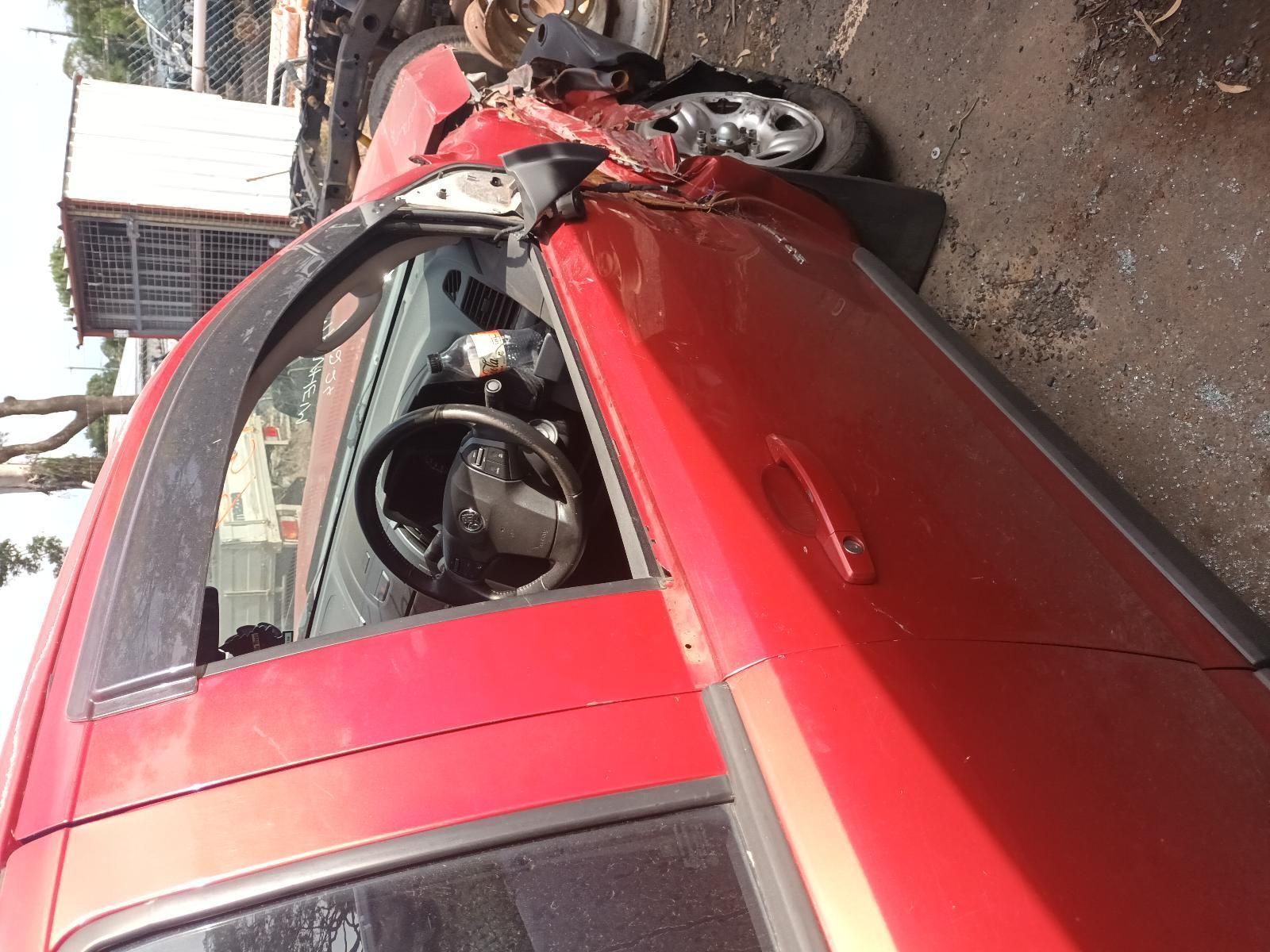 A Red Car with the Door Open is Parked on the Side of the Road — South West 4WD Wreckers In Brisbane, QLD