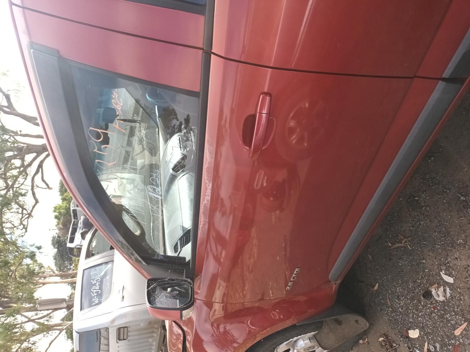 A Red Car is Parked on the Side of the Road — South West 4WD Wreckers In Brisbane, QLD