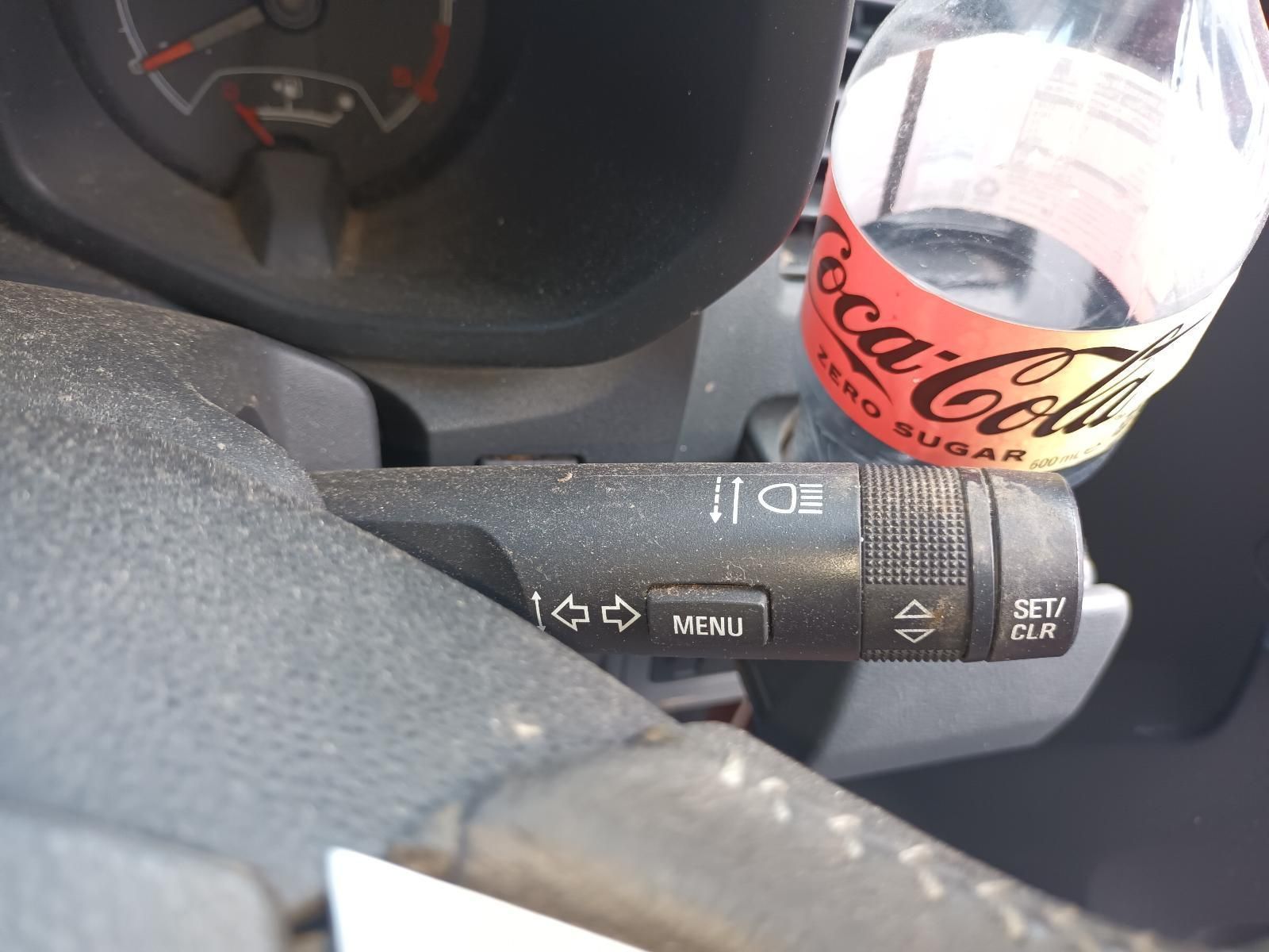 A Bottle of Coca Cola Sits on the Steering Wheel of a Car — South West 4WD Wreckers In Brisbane, QLD