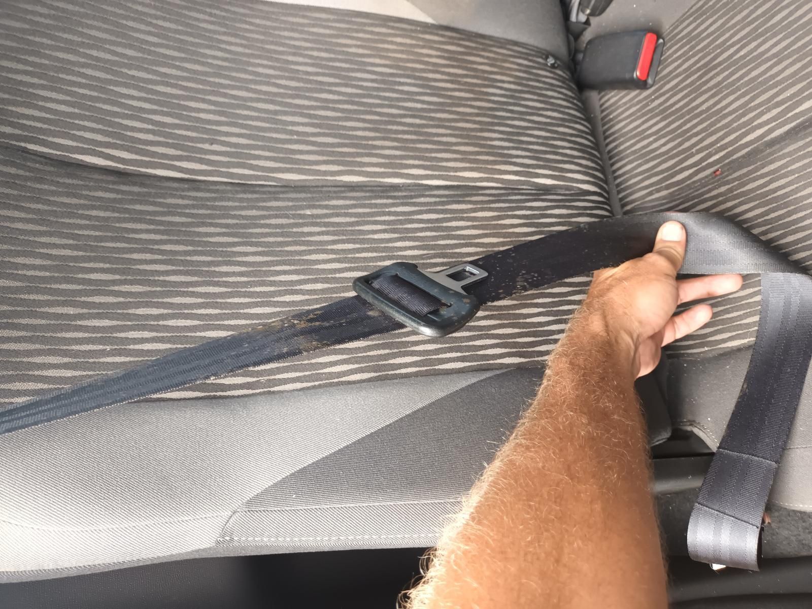 A Person is Holding a Seat Belt in a Car — South West 4WD Wreckers In Brisbane, QLD