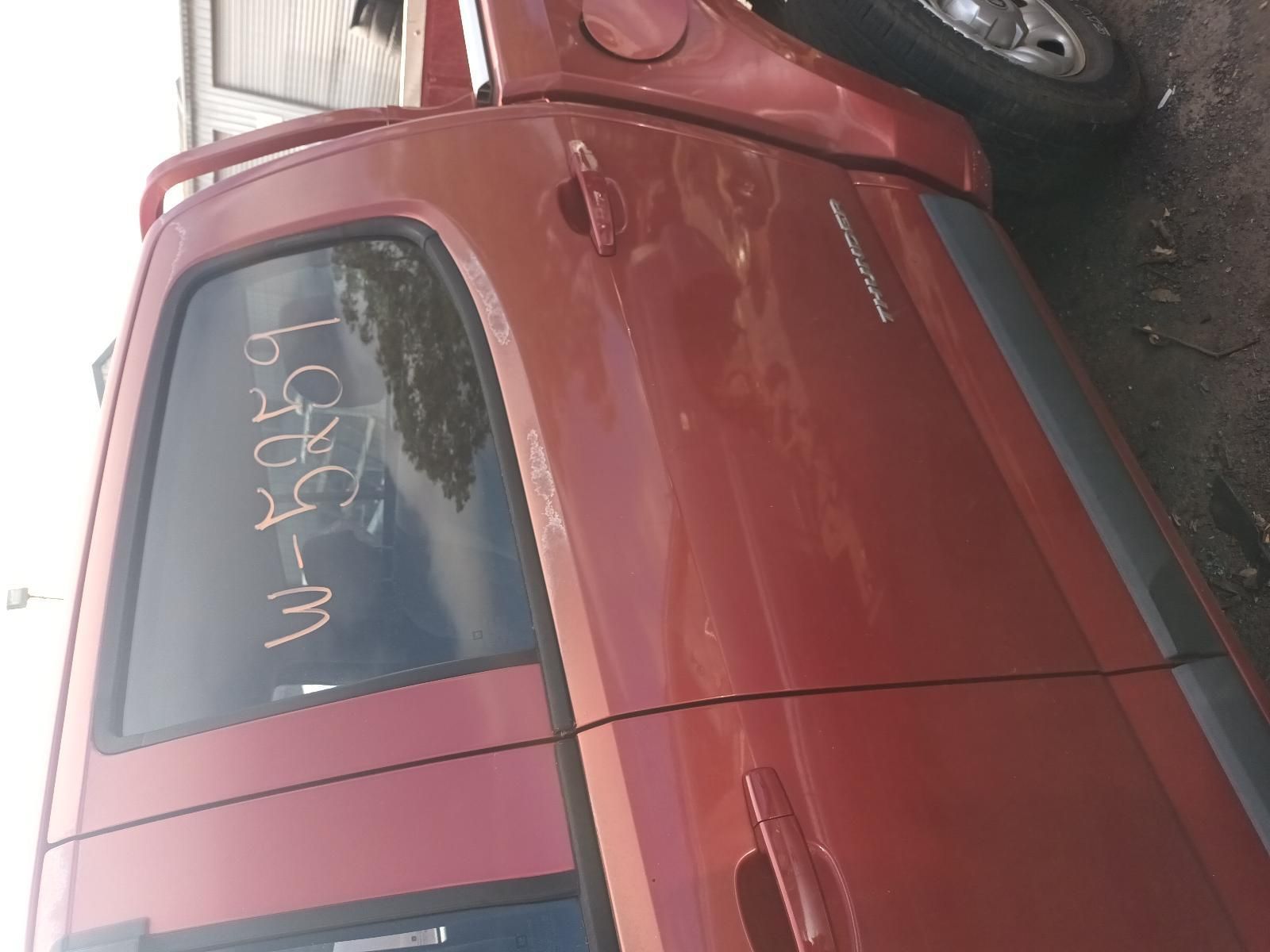 A Red Truck is Parked on the Side of the Road — South West 4WD Wreckers In Brisbane, QLD