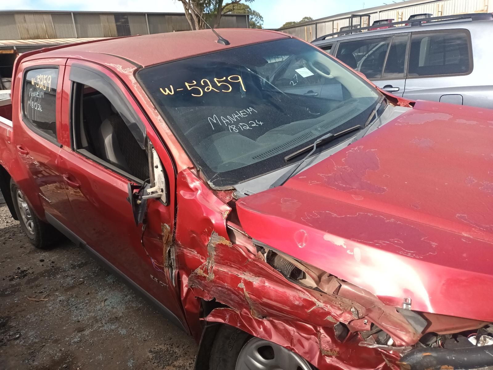 A Red Truck with a Broken Windshield is Parked in a Lot — South West 4WD Wreckers In Brisbane, QLD