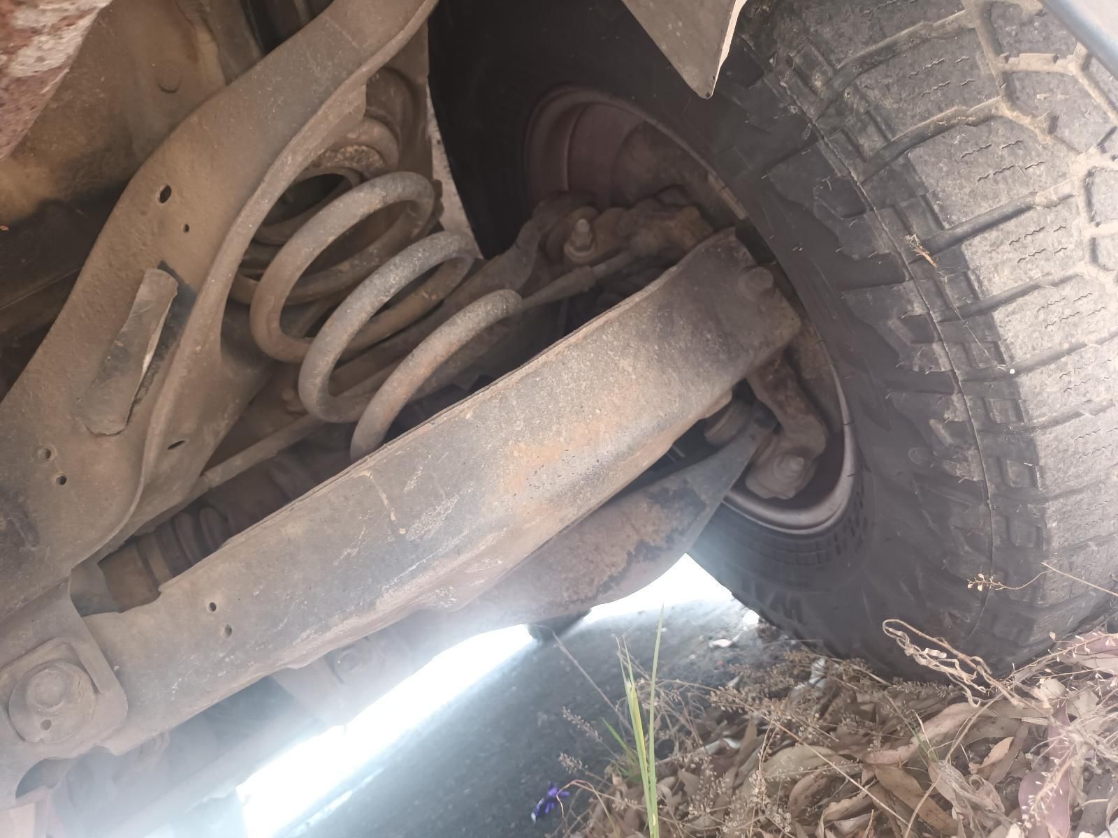 A Close Up of the Underside of a Car with a Tire — South West 4WD Wreckers In Brisbane, QLD