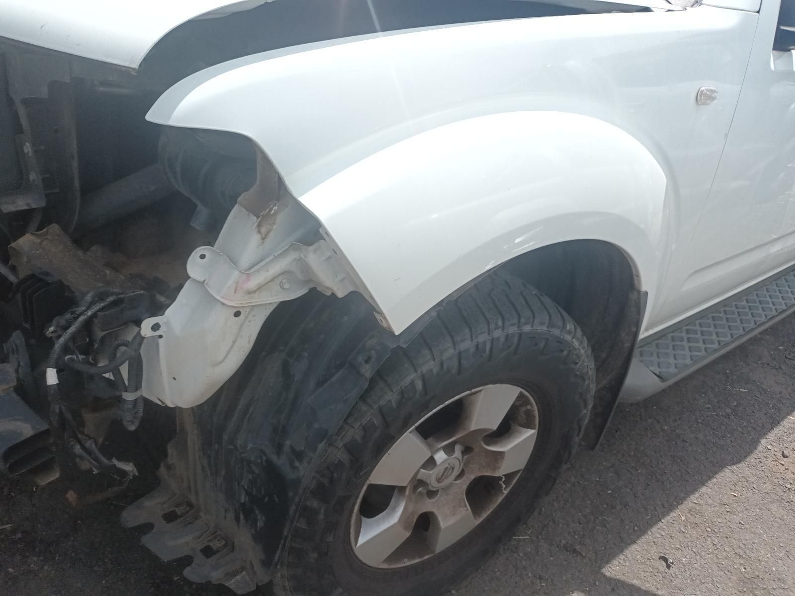 A White Truck with a Broken Fender is Parked on the Side of the Road — South West 4WD Wreckers In Brisbane, QLD