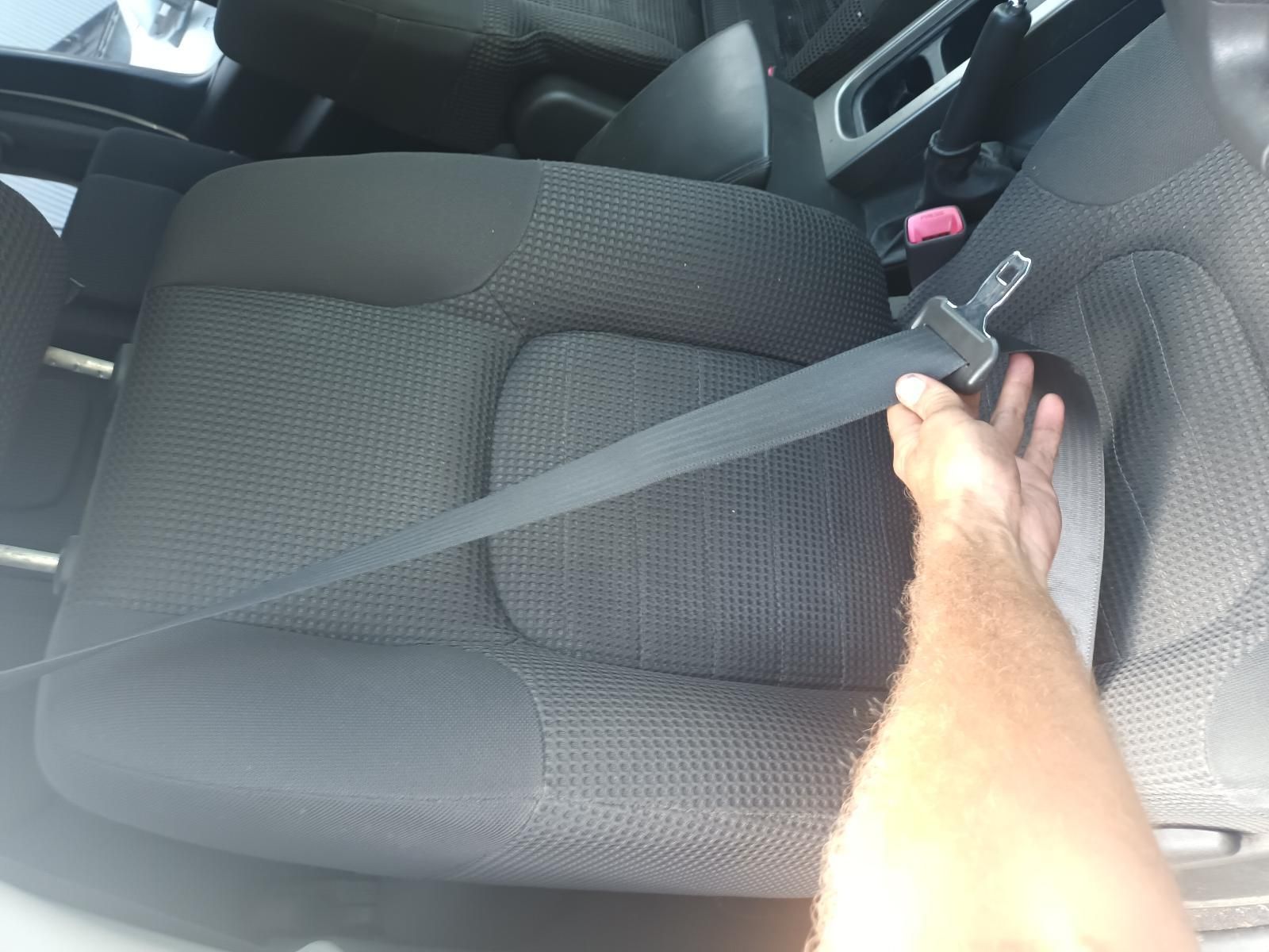 A Person is Putting on a Seat Belt in a Car — South West 4WD Wreckers In Brisbane, QLD