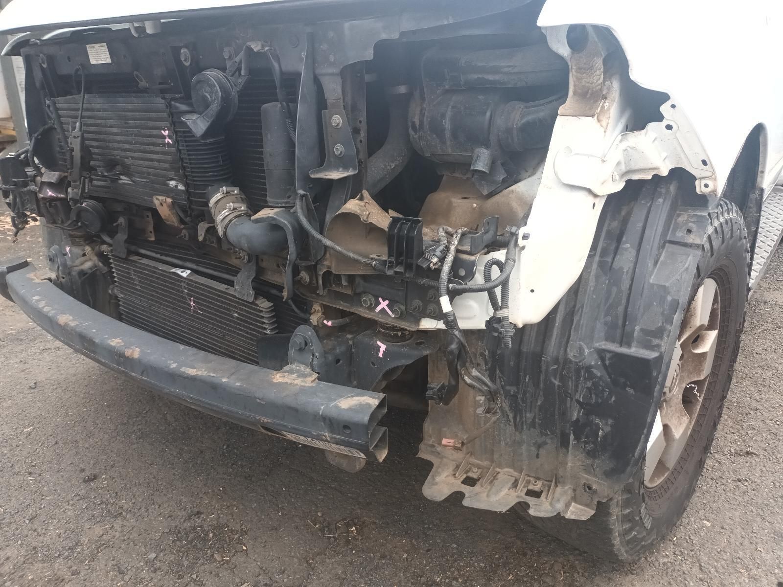 A White Car with a Damaged Front Bumper is Sitting on the Road — South West 4WD Wreckers In Brisbane, QLD