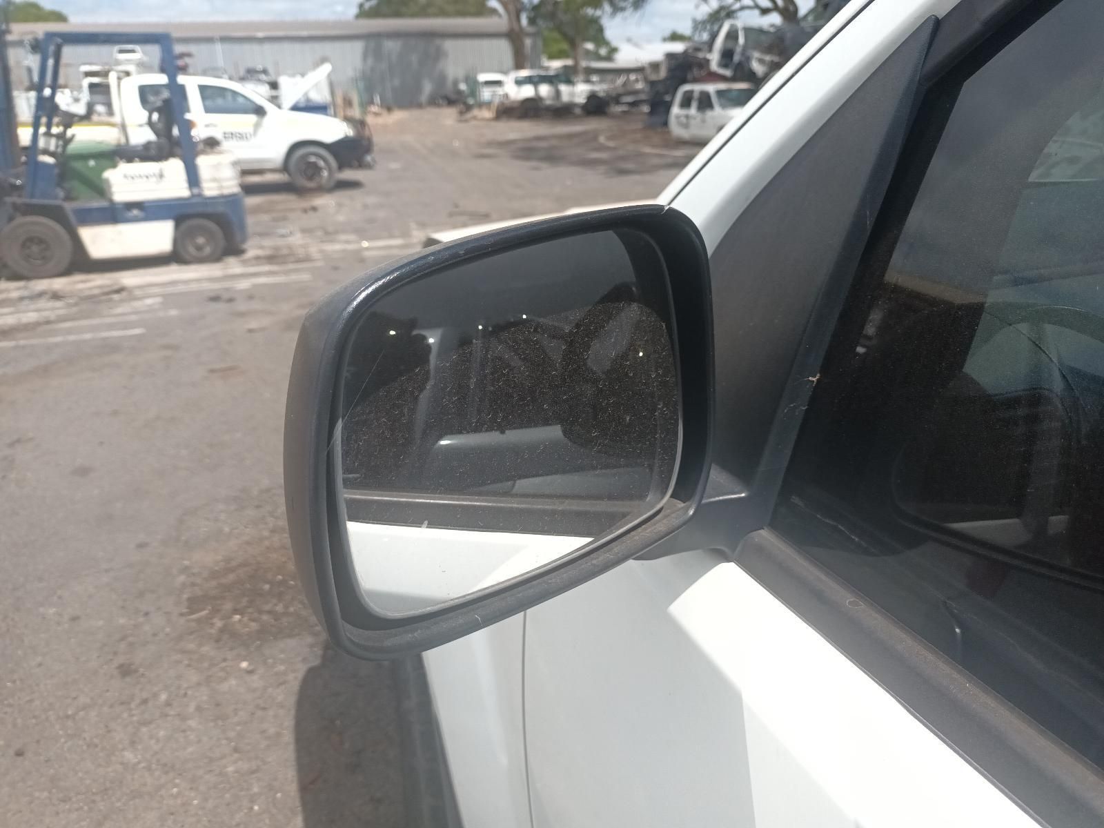 A White Car is Parked in a Parking Lot with a Forklift in the Background — South West 4WD Wreckers In Brisbane, QLD