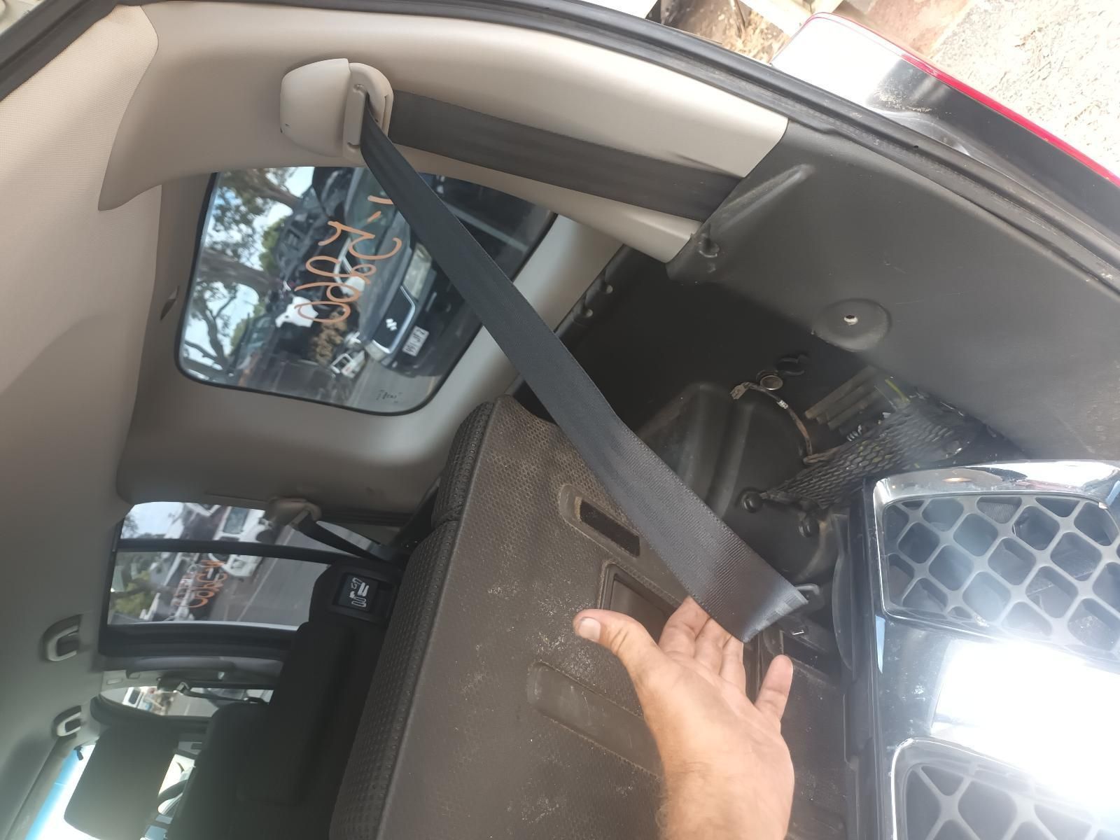 A Person is Putting on a Seat Belt in a Car — South West 4WD Wreckers In Brisbane, QLD