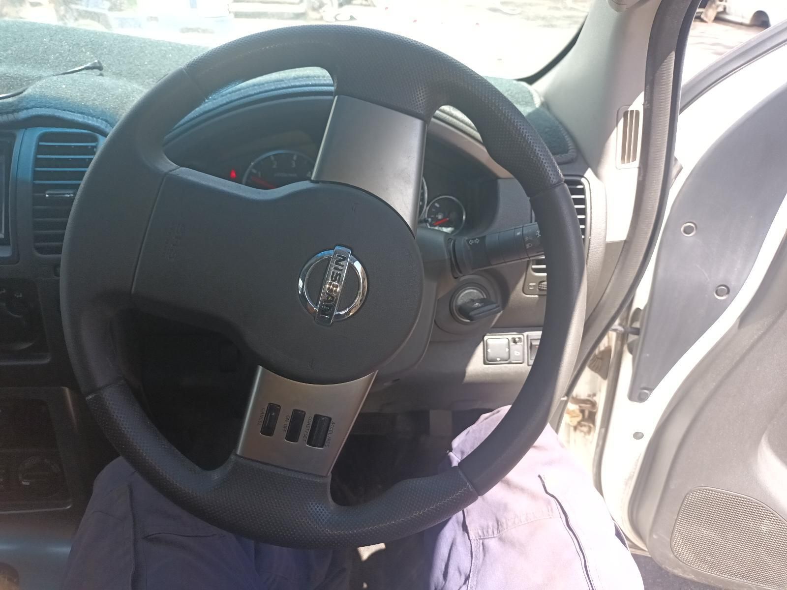 The Steering Wheel of a Nissan Car with the Door Open — South West 4WD Wreckers In Brisbane, QLD