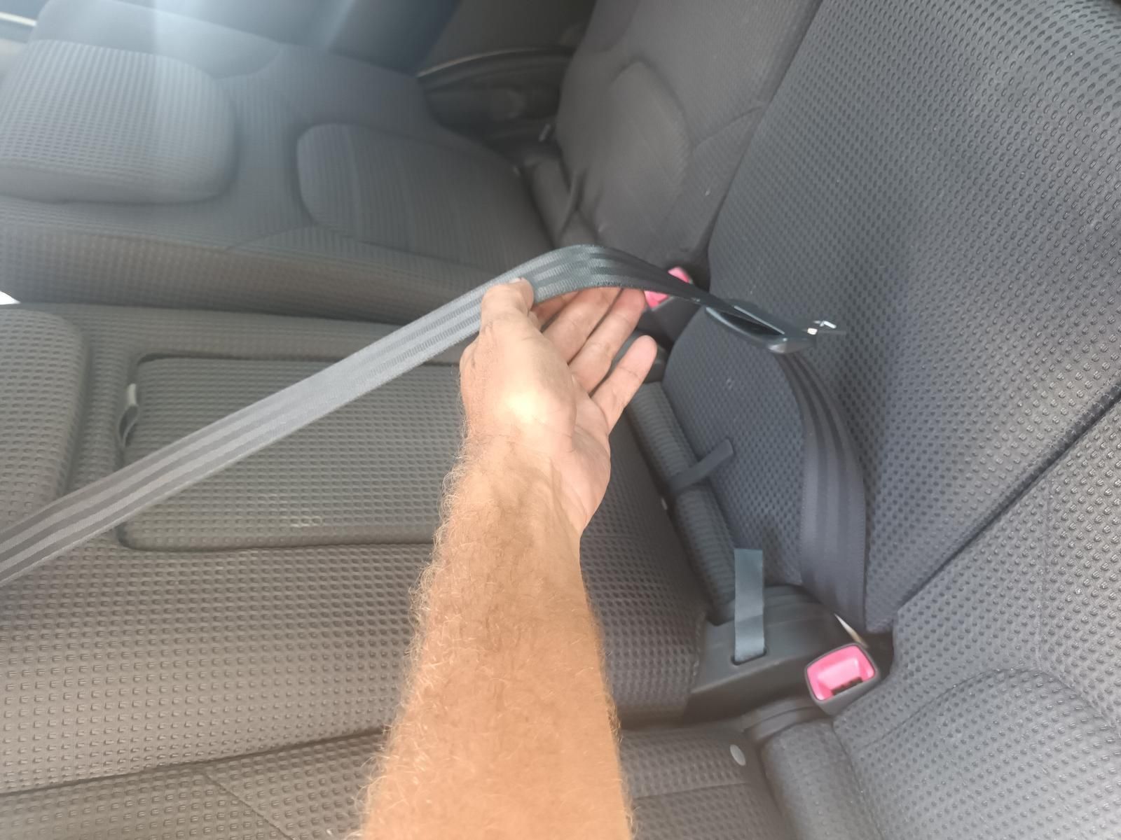 A Person is Putting on a Seat Belt in a Car — South West 4WD Wreckers In Brisbane, QLD