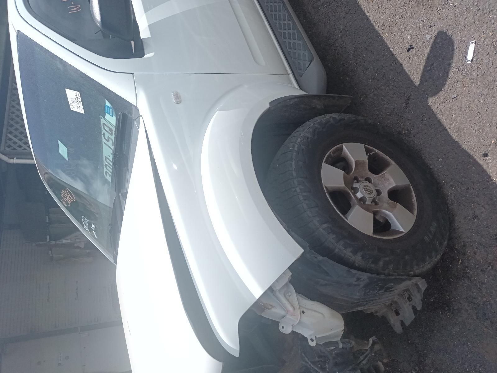A White Car is Parked on the Side of the Road — South West 4WD Wreckers In Brisbane, QLD