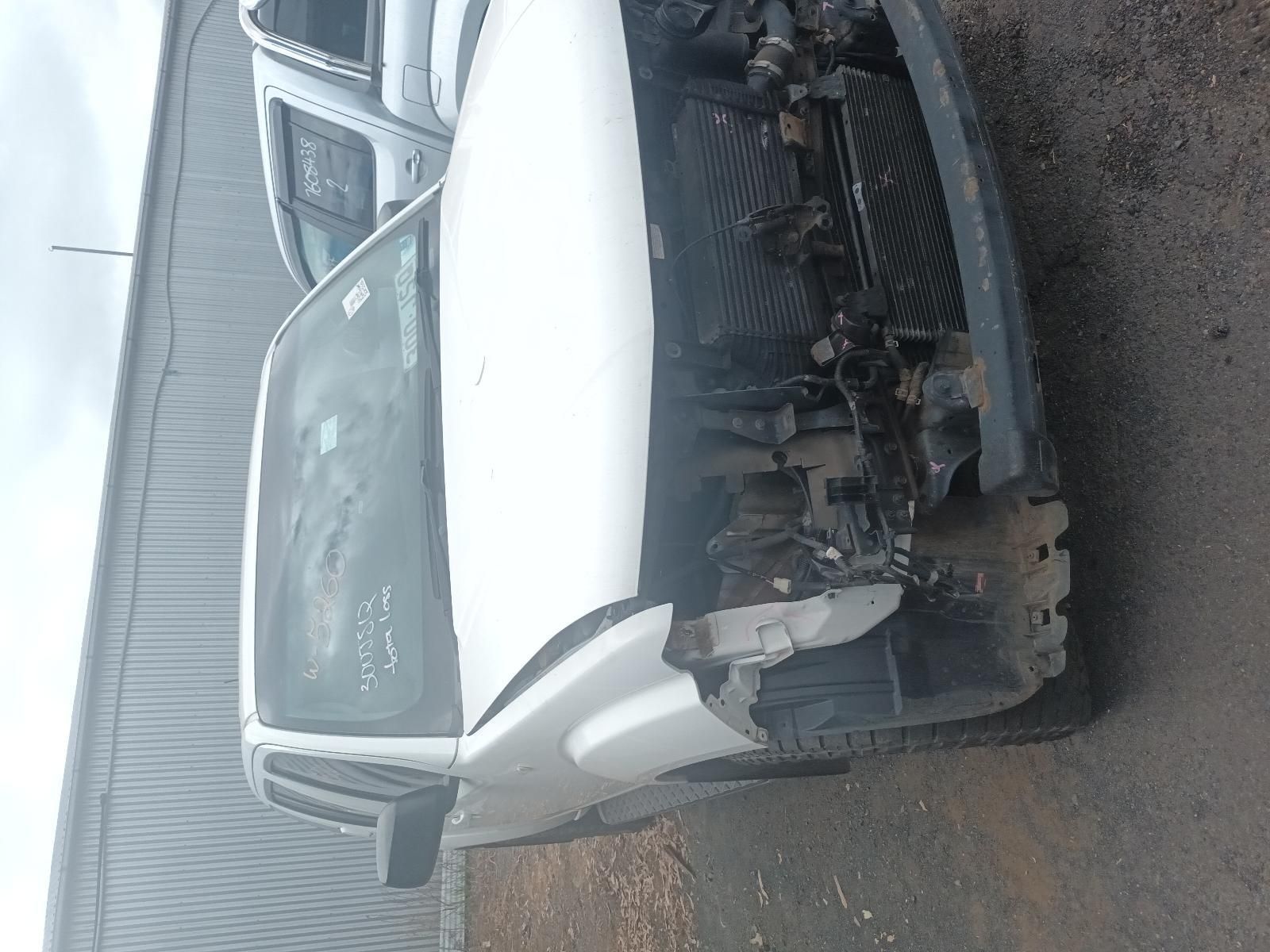 A White Truck with a Broken Hood is Parked on the Side of the Road — South West 4WD Wreckers In Brisbane, QLD