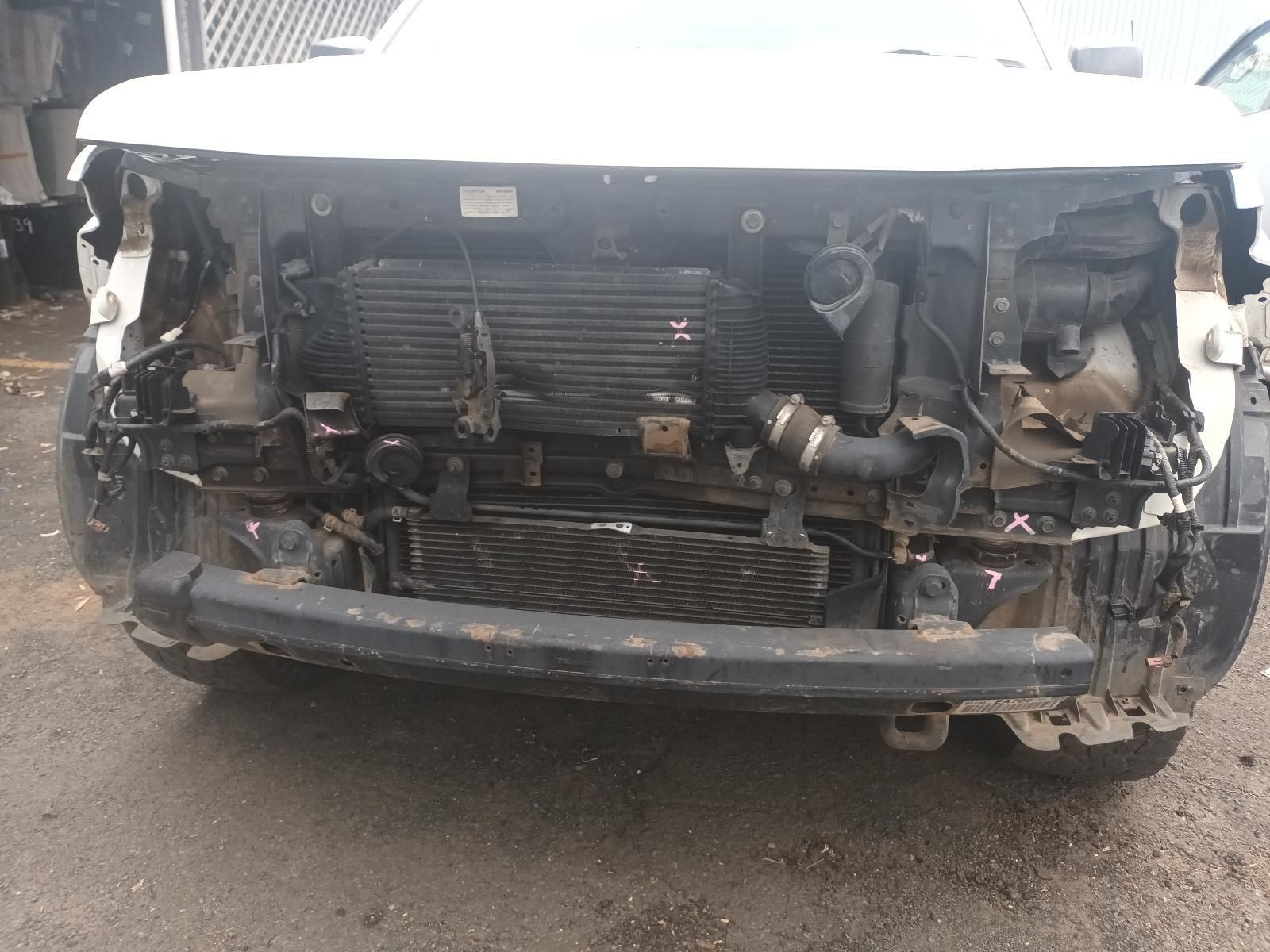 A White Car with the Hood Removed is Parked on the Street — South West 4WD Wreckers In Brisbane, QLD