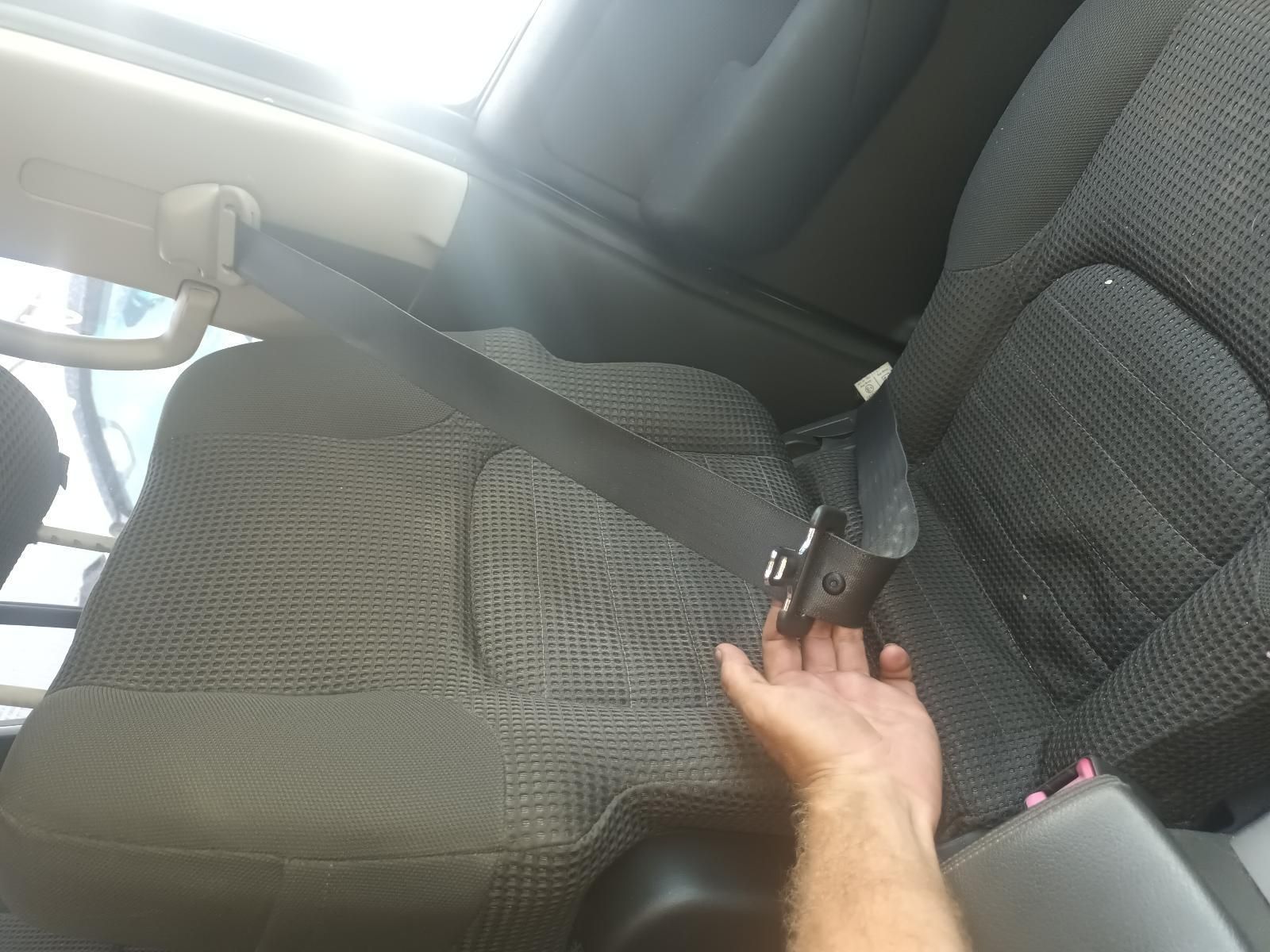 A Person is Putting a Seat Belt on a Car Seat — South West 4WD Wreckers In Brisbane, QLD
