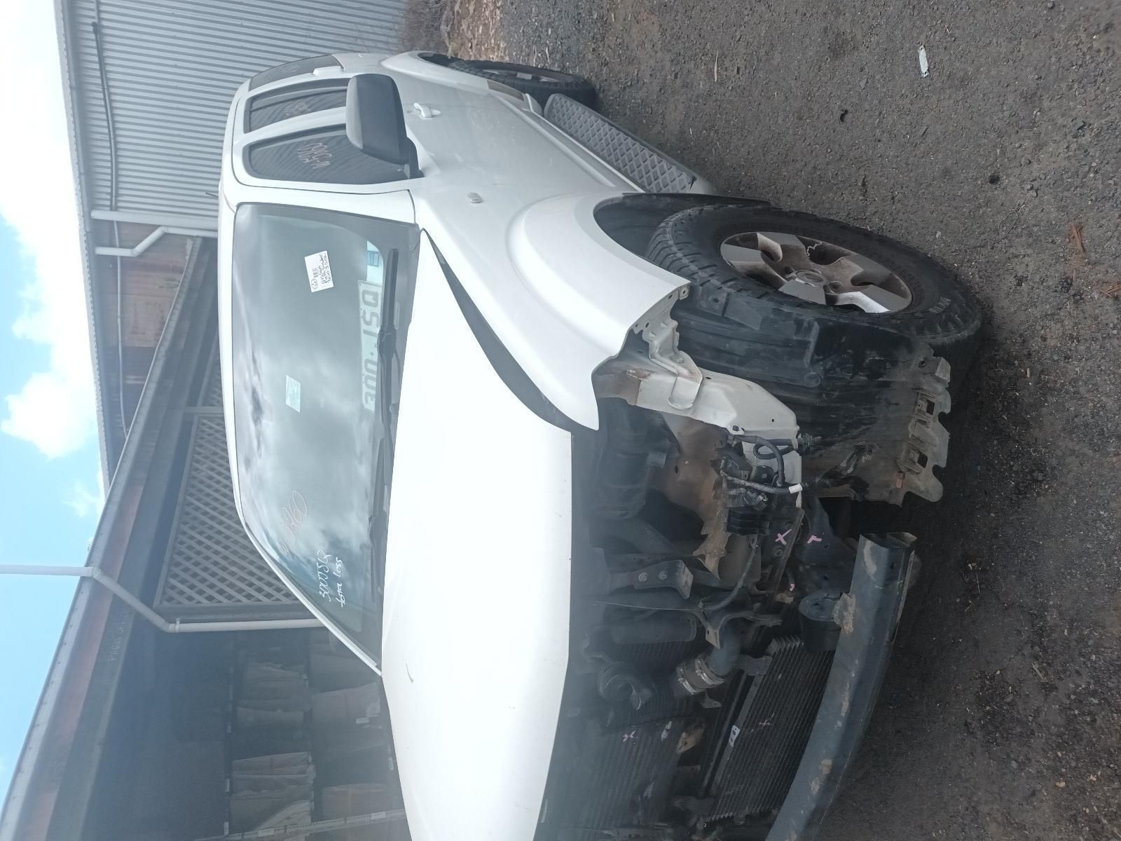 A White Truck with a Damaged Front End is Parked on the Side of the Road — South West 4WD Wreckers In Brisbane, QLD